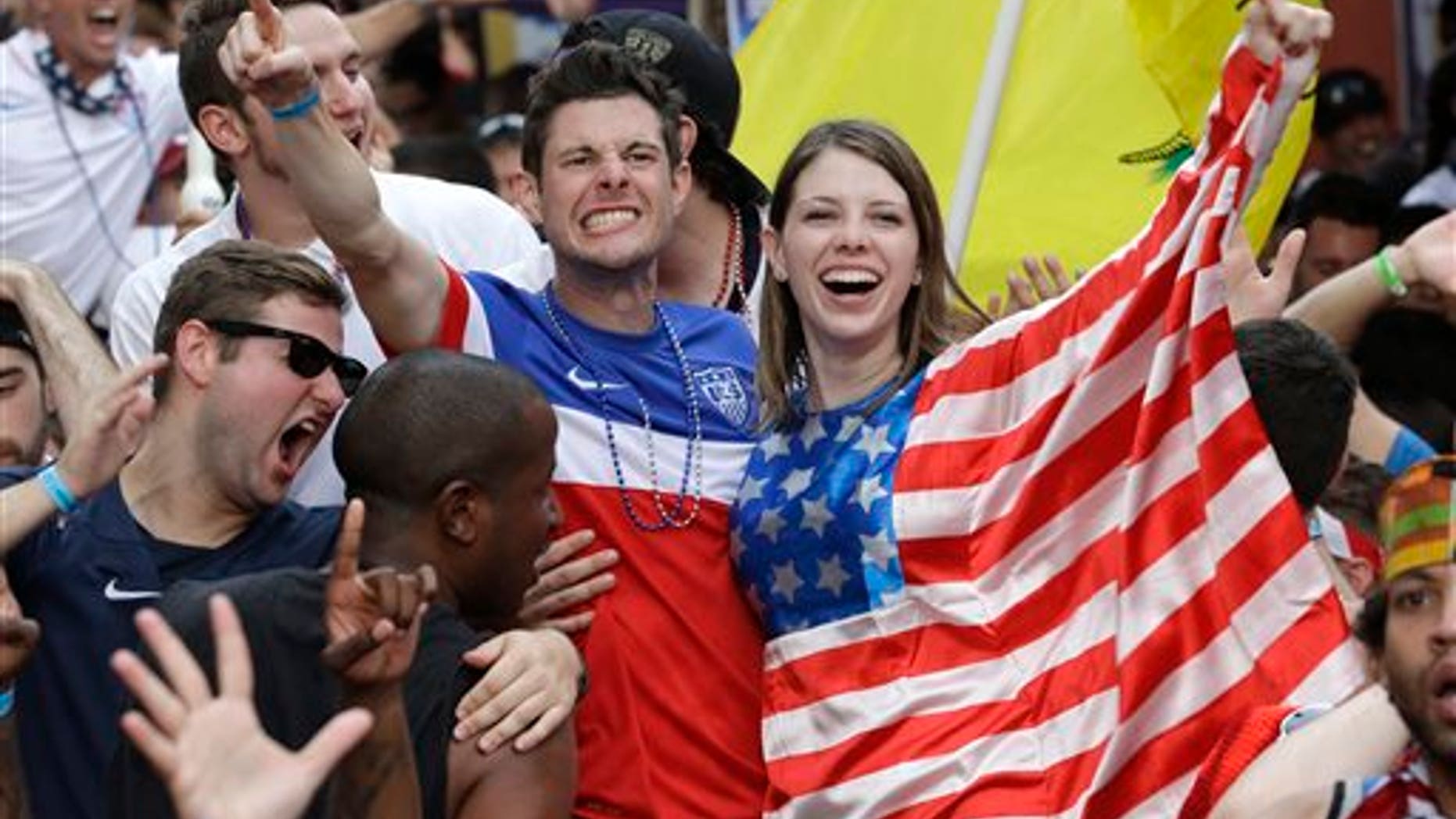 Fans celebrate as the United States scores a goal against Portugal while watching a World Cup soccer match, Sunday, June 22, 2014, in Orlando, Fla. (AP Photo/John Raoux)