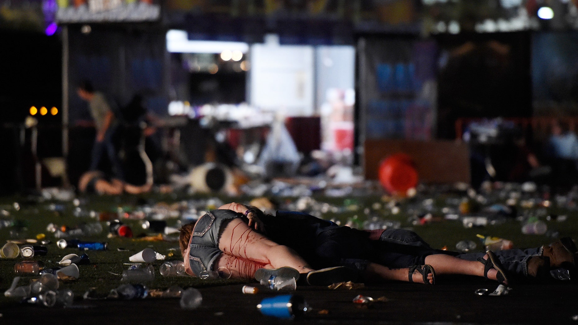 LAS VEGAS, NV - OCTOBER 01: (EDITORS NOTE: Image contains graphic content.) A person lies on the ground covered with blood at the Route 91 Harvest country music festival after apparent gun fire was heard on October 1, 2017 in Las Vegas, Nevada. There are reports of an active shooter around the Mandalay Bay Resort and Casino. (Photo by David Becker/Getty Images)