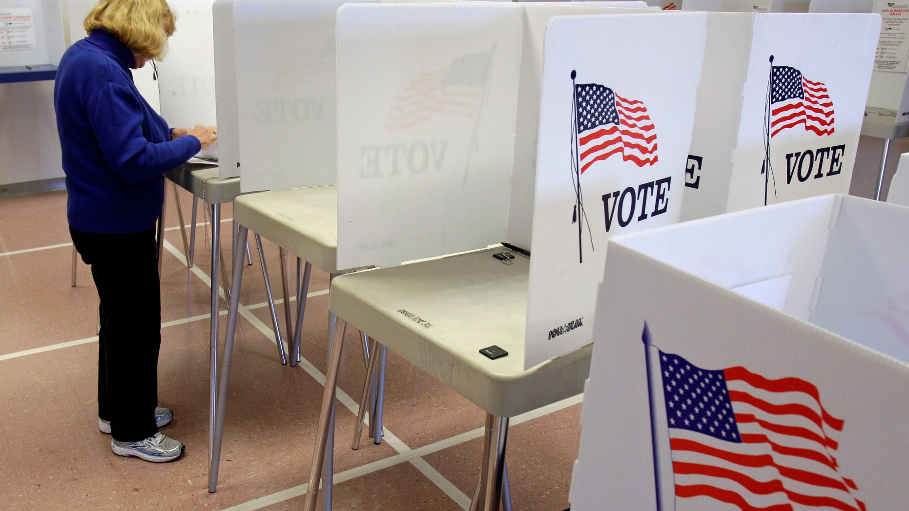 Nancy Suhadolnik of Strongsville, Ohio, votes in early voting Tuesday, Oct. 4, 2011, in Cleveland.