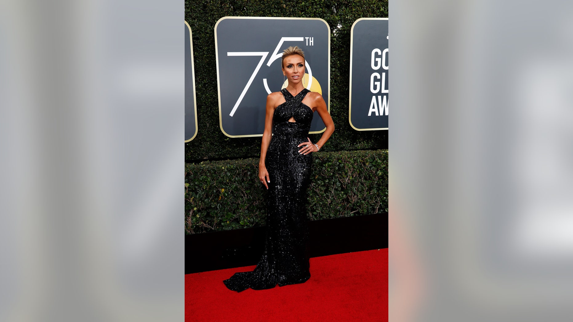 The E! News correspondent donned a sequin black sheath with slicked back hair while hosting the E! Golden Globes red carpet show.