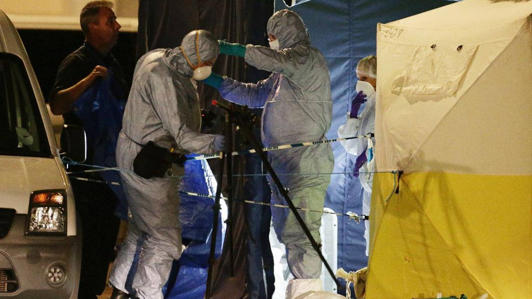 FILE - In this Aug. 4, 2016 file photo, police forensic officers at work in Russell Square, central London, after a knife attack. A teenager has admitted killing a retired Florida teacher and injuring five other people in a stabbing rampage near the British Museum in London. Somali-Norwegian Zakaria Bulhan, 19, pleaded guilty to manslaughter by diminished responsibility in the Aug. 3 slaying of 64-year-old Darlene Horton. He also pleaded guilty to five counts of wounding during a hearing Monday, Feb. 6, 2017 at London's Central Criminal Court. (Yui Mok/PA via AP, file)