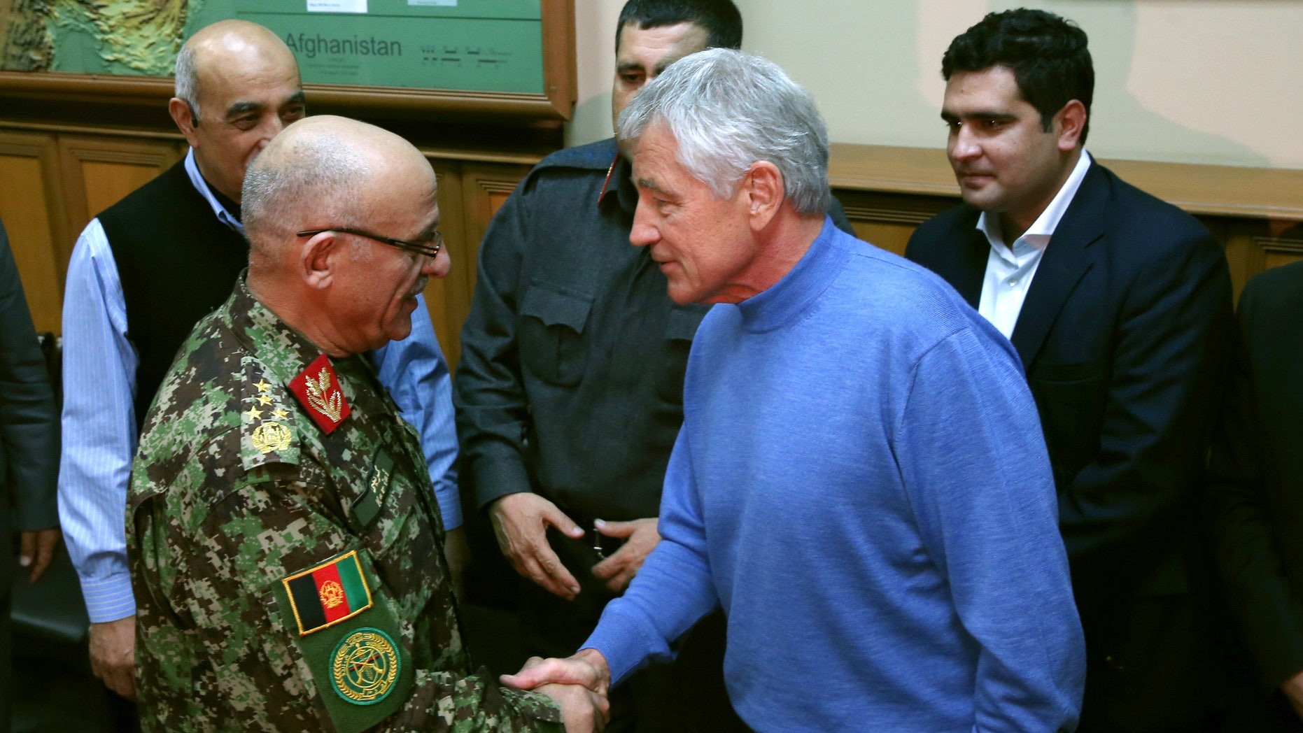 U.S. Secretary of Defense Chuck Hagel, right, shakes hands with Afghan Gen. Sher Mohammad Karimi, left, during a meeting at the International Security Assistance Force Headquarters (ISAF) on Saturday, Dec. 7, 2013 in Kabul, Afghanistan. Secretary Hagel made a stop in Afghanistan during his six-day trip to the Middle East. (AP Photo/Mark Wilson, Pool)