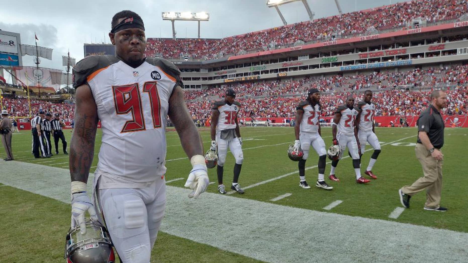 Tampa Bay Buccaneers defensive end Da'Quan Bowers (91) and leave the field during a weather warning in the second quarter of an NFL football game against the St. Louis Rams, Sunday, Sept. 14, 2014, in Tampa, Fla. (AP Photo/Phelan M. Ebenhack)