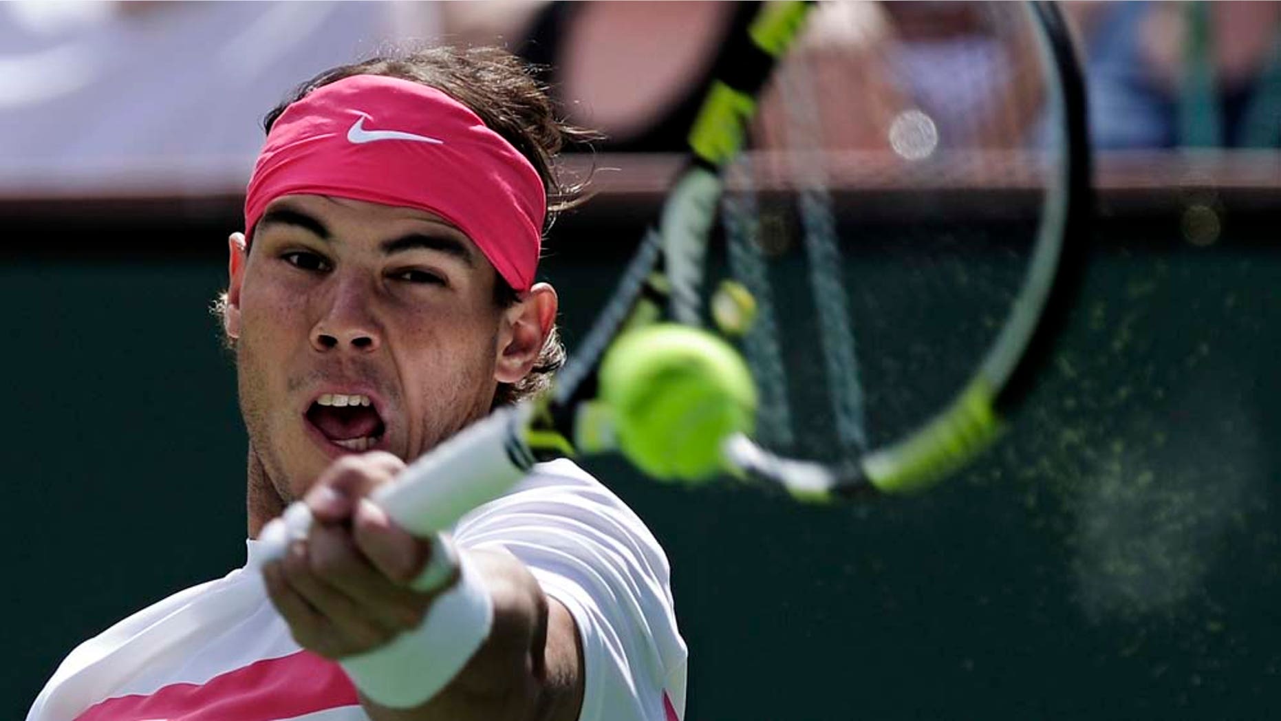 FILE - In this March 20, 2010 file photo, Rafael Nadal of Spain returns a shot to Ivan Ljubicic of Croatia during their match at the BNP Paribas Open tennis tournament in Indian Wells, Calif. This image is one in a portfolio of 12 by AP photographer Mark J. Terrill which won the AP's Thomas V. diLustro award for best portfolio in the annual contest for AP staffers judged by the Associated Press Sports Editors at their winter meeting. (AP Photo/Mark J. Terrill, File)