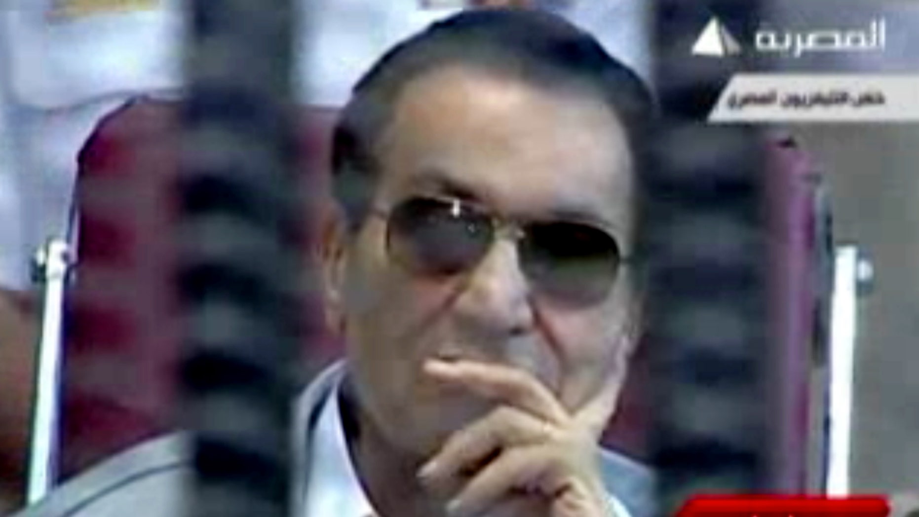 This image made from video broadcast on Egyptian state television shows former President Hosni Mubarak inside the defendant's cage in a courtroom in Cairo, Egypt, Saturday, May 11, 2013. The retrial of former Egyptian President Hosni Mubarak resumed Saturday, with prosecutors requesting to present new evidence from a fact-finding commission's report that claims the ex-leader had full knowledge of the extent of the violence used against protesters. (AP Photo/Egyptian State Television via AP video)