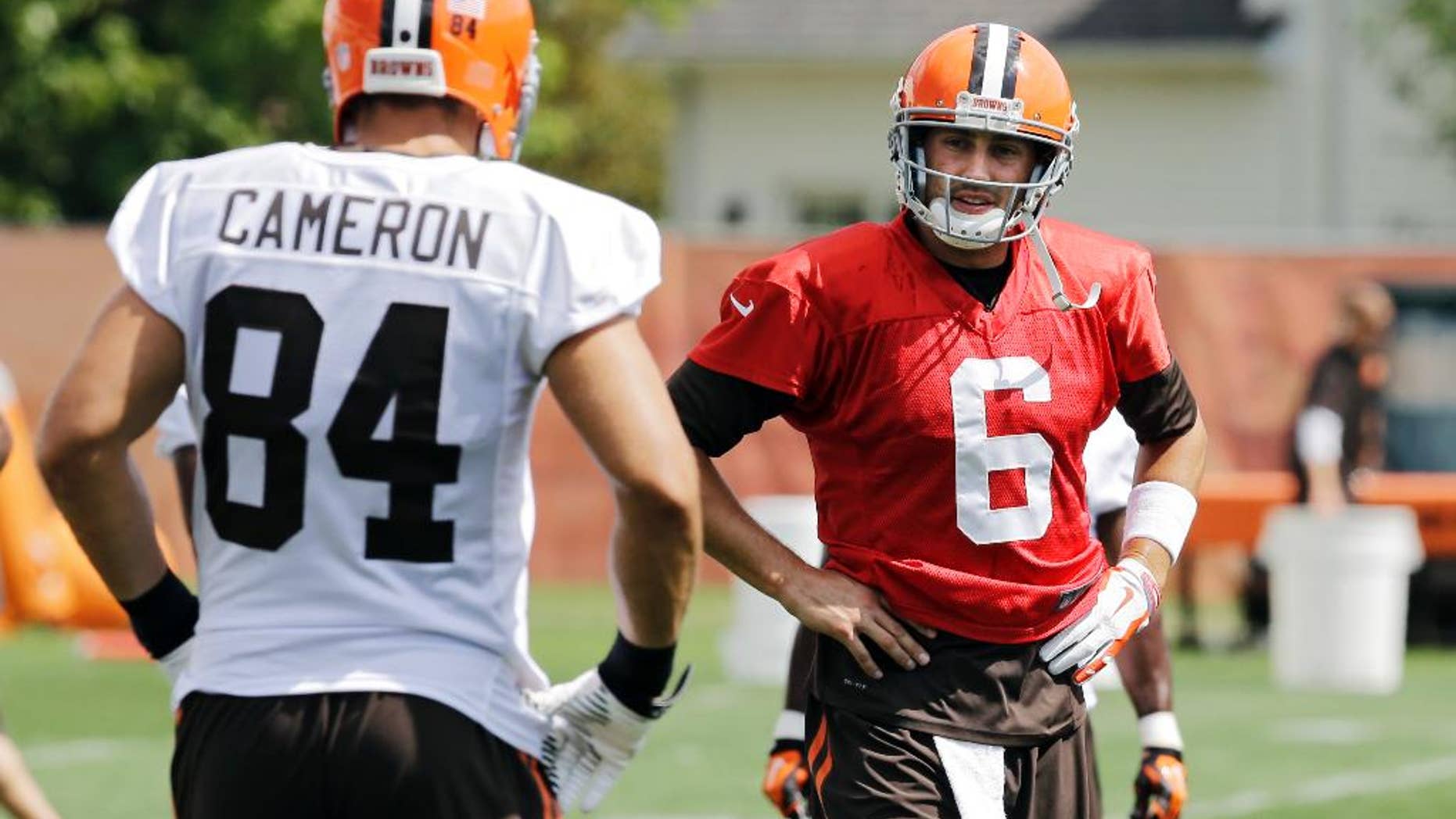 Cleveland Browns quarterback Brian Hoyer (6) talks to tight end Jordan Cameron (84) during practice at the NFL football team's facility in Berea, Ohio Wednesday, Sept. 3, 2014. (AP Photo/Mark Duncan)