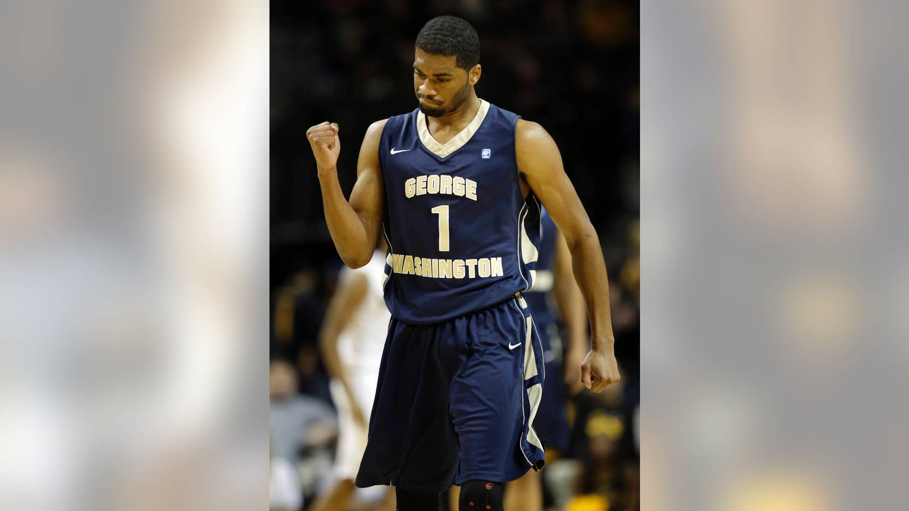 George Washington's Maurice Creek celebrates after his team scored during the first half of an NCAA college basketball game against VCU in the semifinal round of the Atlantic 10 Conference tournament at the Barclays Center in New York, Saturday, March 15, 2014. (AP Photo/Seth Wenig)