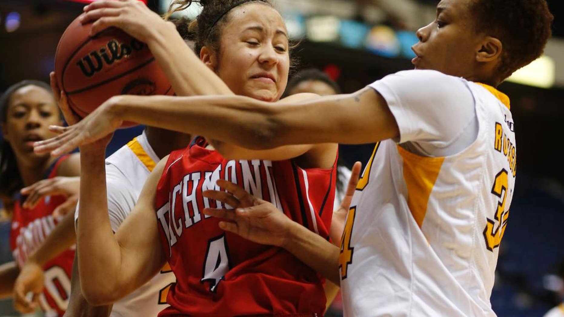 Richmond's Janelle Hubbard (4) gets pressure on a rebound from Virginia Commonwealth's Keira Robinson during a second round game at the Atlantic 10 women's NCAA college basketball tournament in Richmond, Va., Thursday, March 6, 2014. (AP Photo/The Richmond Times-Dispatch, Joe Mahoney)