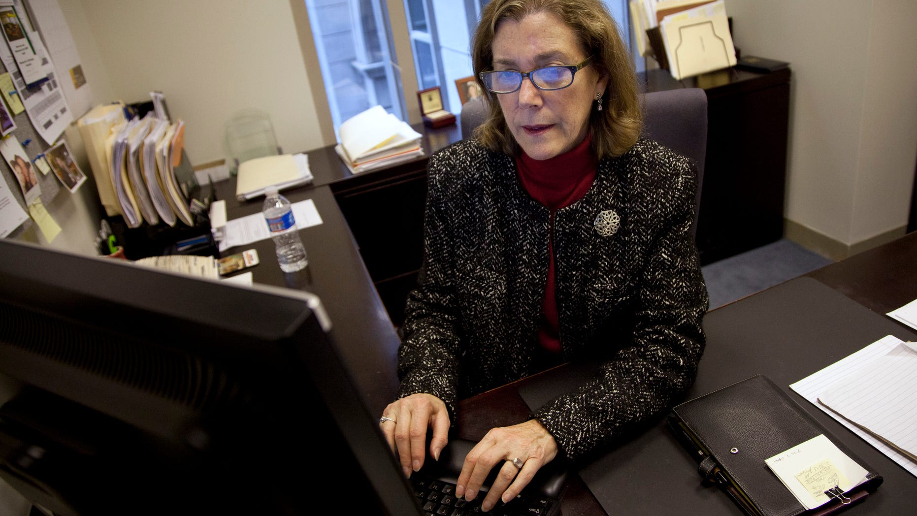 Lynn Feinberg, a caregiver expert at AARP, works in her office. (AP Photo/Evan Vucci)
