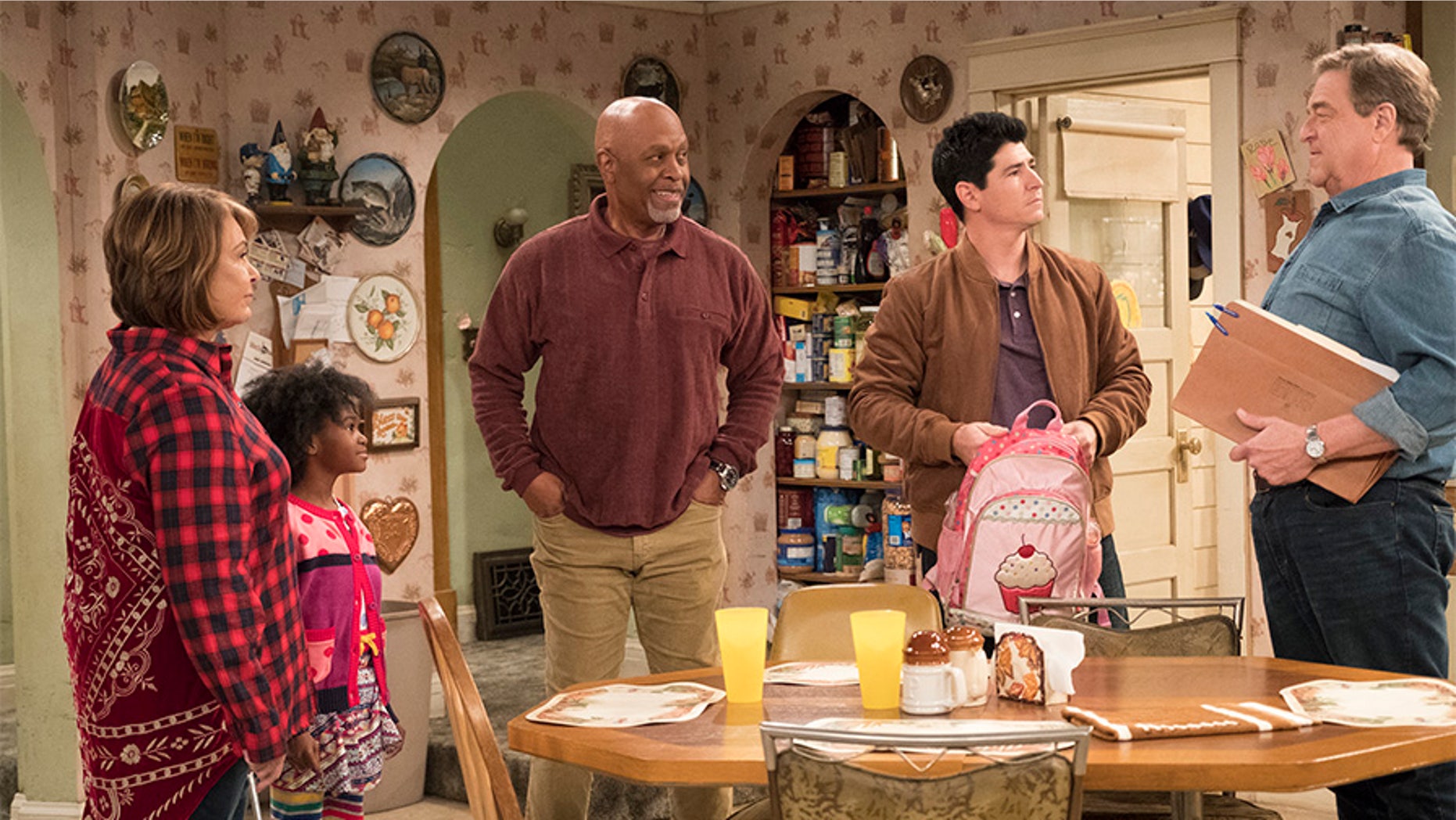 Michael Fishman (holding pink backpack) during the episode "Go Cubs" from the "Roseanne" reboot.