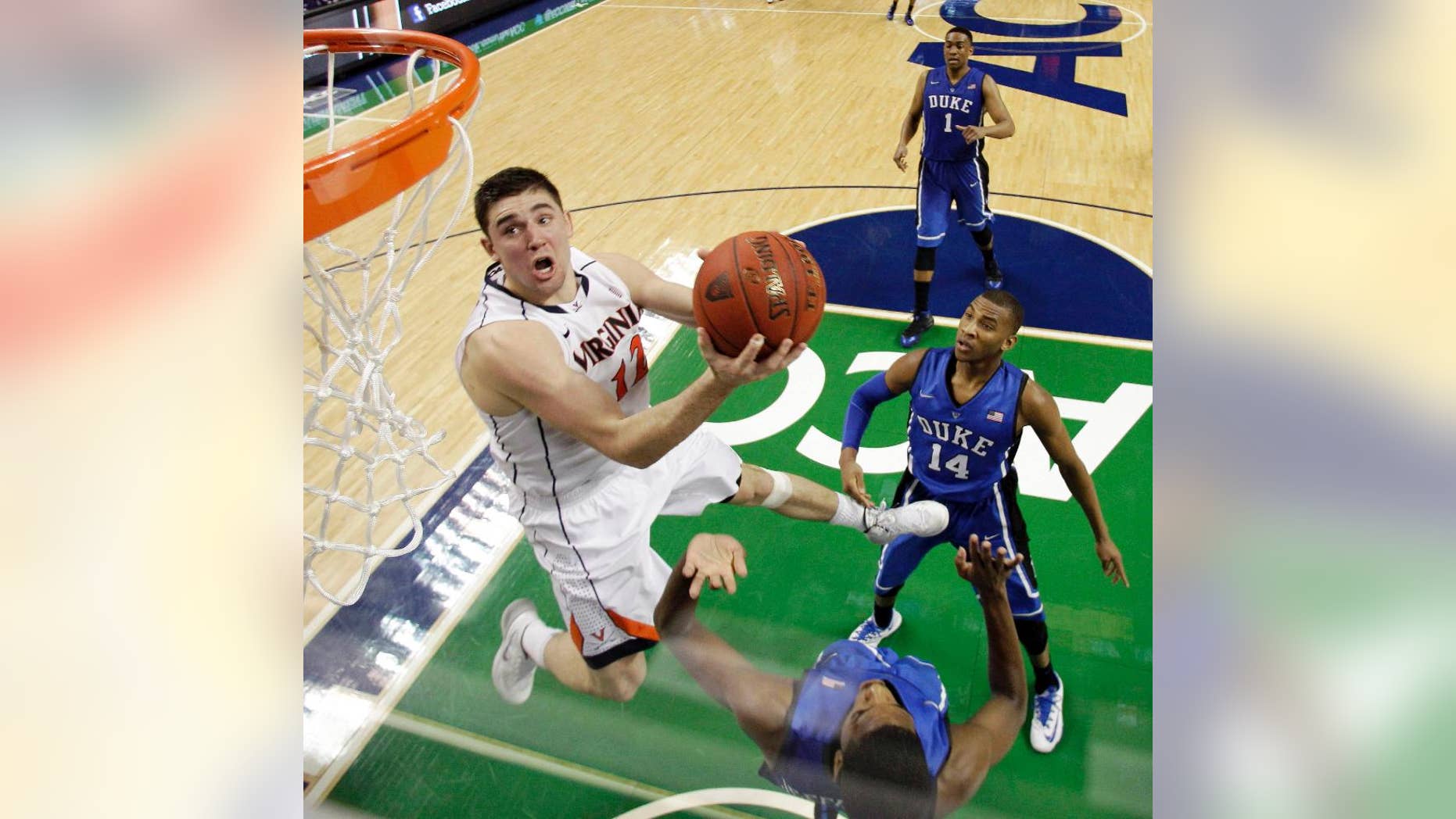 FILE - In this March 16, 2014, file photo, Virginia's Joe Harris (12) goes to the basket against Duke in the second half of an NCAA college basketball game in the championship of the Atlantic Coast Conference tournament in Greensboro, N.C. The ACC is taking its men's basketball tournament from Tobacco Road to the bright lights of New York. A person familiar with the situation said Tuesday, March 25, the league has completed a two-year deal to bring the tournament to Brooklyn's Barclays Center starting in 2017. (AP Photo/Bob Leverone, File)