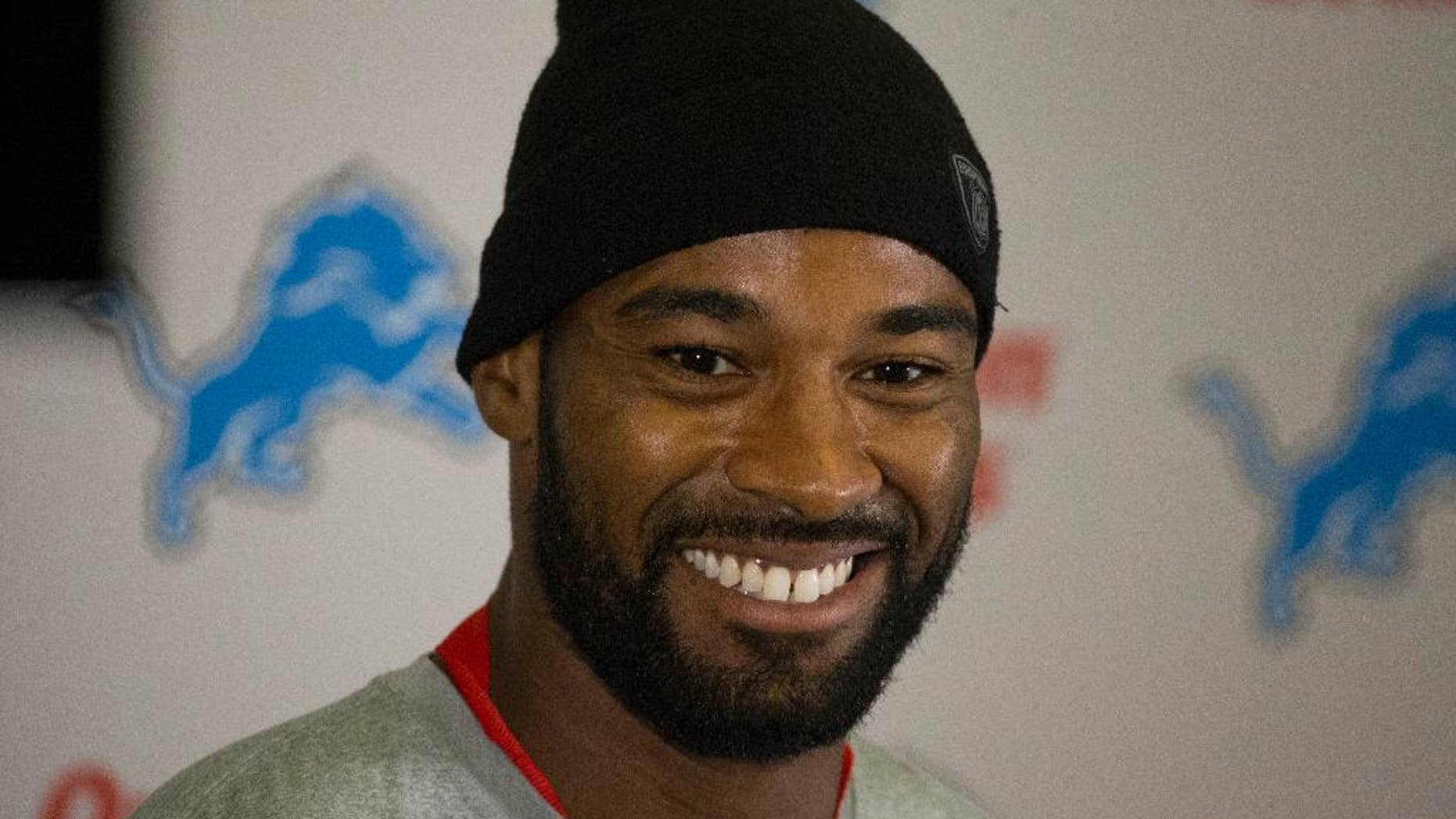 ADDS NAME OF PLAYER - Detroit Lions wide receiver Calvin Johnson smiles during a press conference at Pennyhill Park Hotel in Bagshot, England, Thursday, Oct. 23, 2014. The Atlanta Falcons will play the Detroit Lions in an NFL football game at London's Wembley Stadium on Sunday. (AP Photo/Matt Dunham)