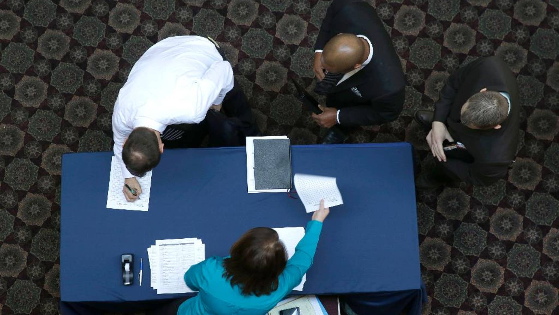 FILE - In this Wednesday, Jan. 22, 2014, file photo, job seekers sign in before meeting prospective employers during a career fair at a hotel in Dallas. Payroll processor ADP reports on job growth at U.S. companies in February, on Wednesday, March 5, 2014. (AP Photo/LM Otero, File)