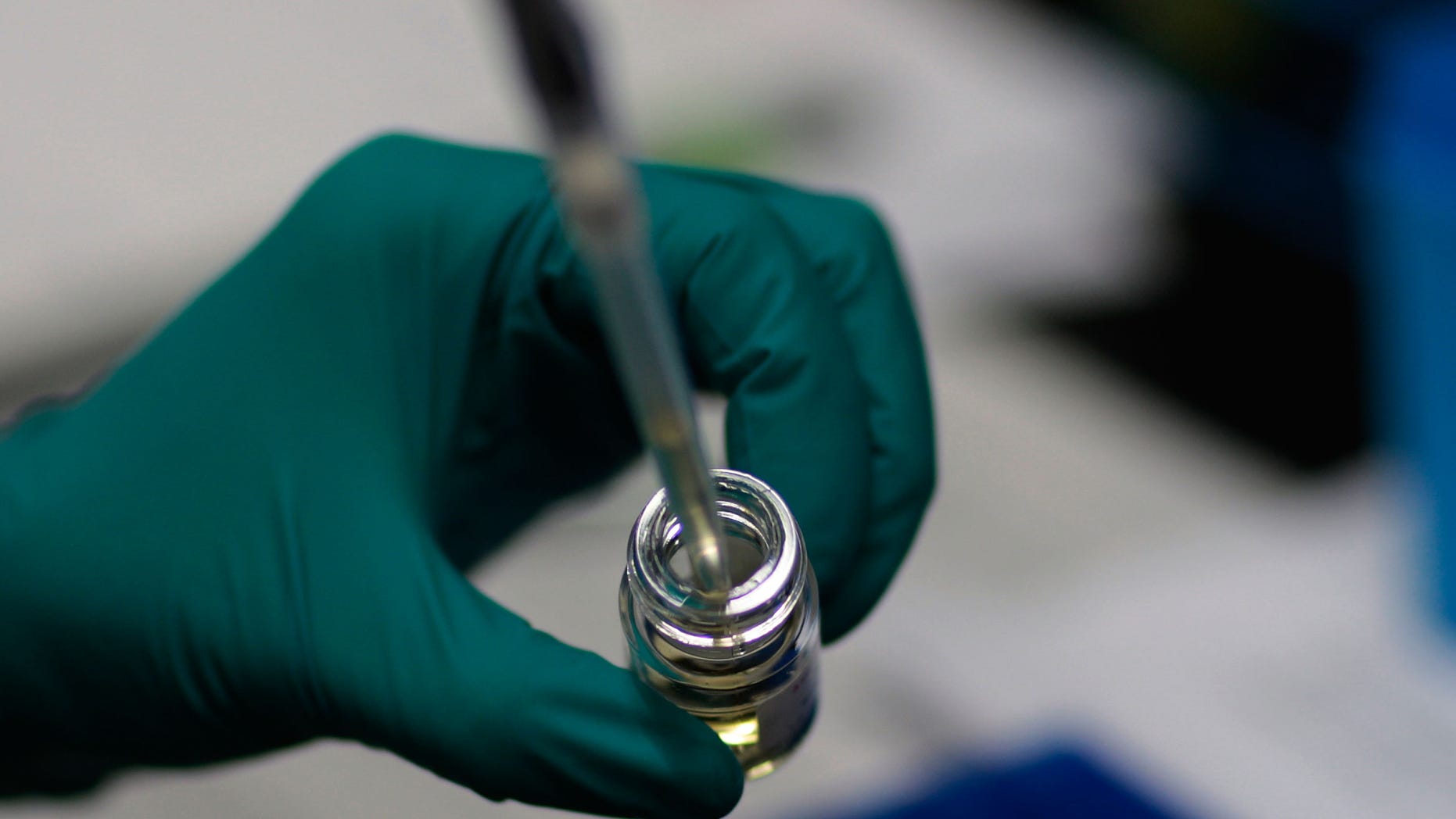 NEW YORK - DECEMBER 1: A researcher extracts fluid from a vial at the AIDS Vaccine Design and Development Laboratory at the laboratory's campus in the former Brooklyn Army Terminal December 1, 2008 in New York City. The laboratory is part of the International AIDS Vaccine Initiative (or IAVI), a global not-for-profit, public-private partnership working to accelerate the development of a vaccine to prevent HIV infection and AIDS. December 1 is the 20th annual World AIDS Day around the world. (Photo by Chris Hondros/Getty Images)