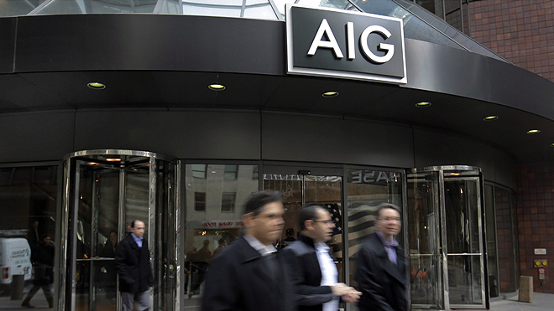 Jan. 8, 2013: People pass the AIG building in New York. American International Group Inc. said Tuesday its board of directors will weigh whether to take part in a shareholder lawsuit against the U.S. over the government's $182 billion bailout of the insurer. (AP)