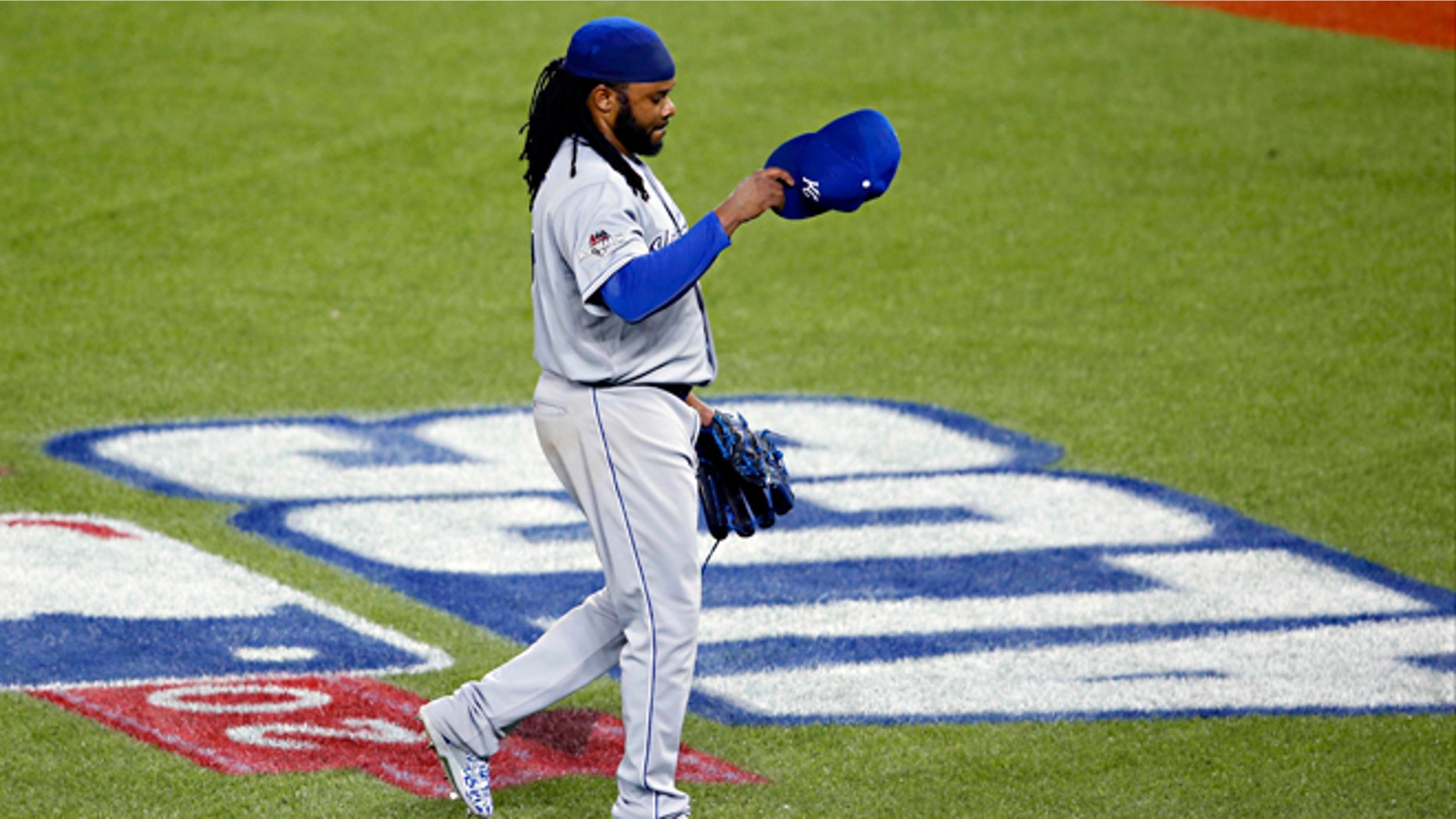 Kansas City Royals starting pitcher Johnny Cueto leaves the game against the Toronto Blue Jays during the third inning in Game 3 of baseball's American League Championship Series on Monday, Oct. 19, 2015, in Toronto. (AP Photo/Paul Sancya)