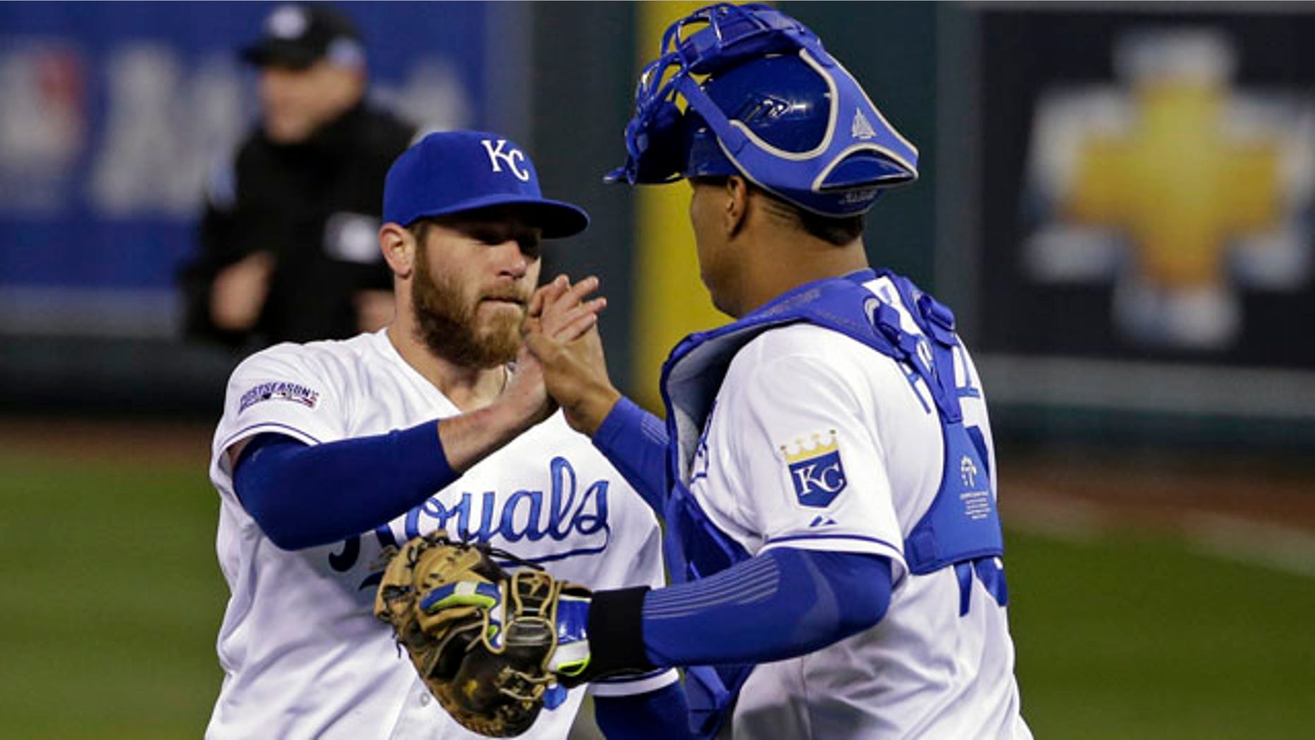 October 14, 2014: Kansas City Royals relief pitcher Greg Holland is congratulated by Salvador Perez following Game 3 of the American League baseball championship series, in Kansas City, Mo. (AP Photo/Matt Slocum )