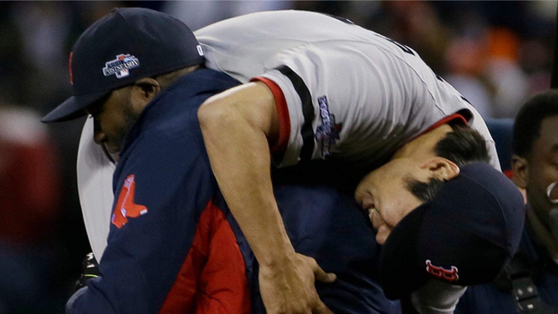 Boston Red Sox's David Ortiz picks up Koji Uehara after the Red Sox defeating the Detroit Tigers 4-3 in Game 5 of the American League baseball championship series Thursday, Oct. 17, 2013, in Detroit. (AP Photo/Matt Slocum)