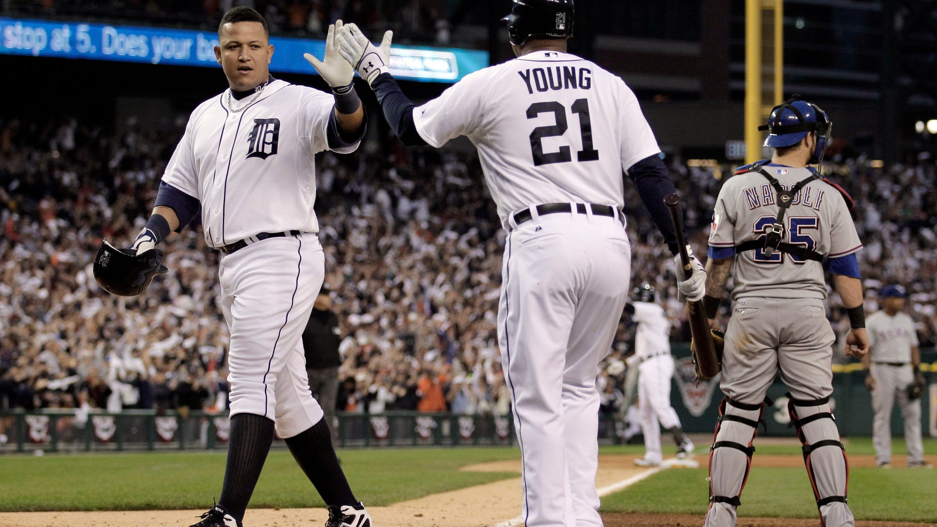 Detroit Tigers' Miguel Cabrera is met at home plate by teammate Delmon Young after scoring in the sixth inning in Game 5 of baseball's American League championship series against the Texas Rangers Thursday, Oct. 13, 2011, in Detroit. (AP Photo/Charlie Riedel)