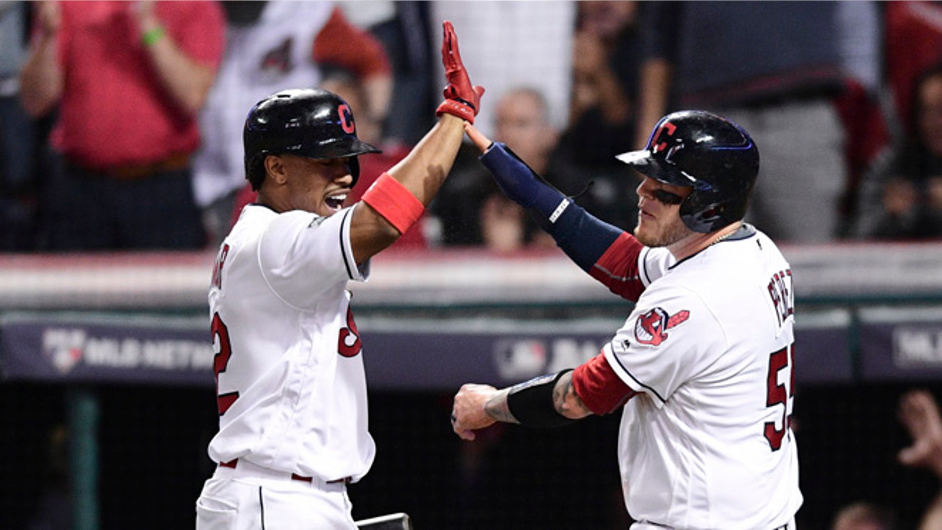 Cleveland Indians' Roberto Perez, right, celebrates with Francisco Lindor after scoring on a Jason Kipnis single against the Boston Red Sox in the fifth inning during Game 1 of baseball's American League Division Series, Thursday, Oct. 6, 2016, in Cleveland.