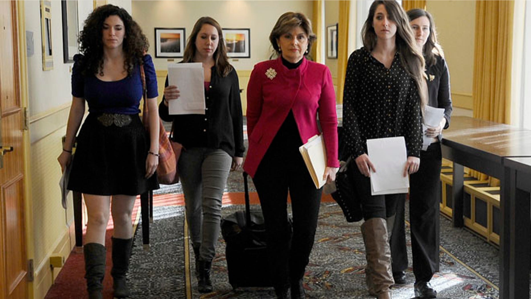Oct. 21: Attorney Gloria Allred, center, walks with University of Connecticut students Rose Richi, left, Erica Daniels, Carolyn Luby, second from right, and Kylie Angell, right, to a news conference in Hartford.
