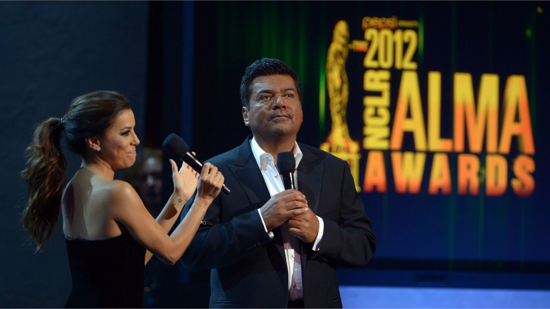 PASADENA, CA - SEPTEMBER 16: Hosts Eva Longoria and George Lopez speak onstage at the 2012 NCLR ALMA Awards at Pasadena Civic Auditorium on September 16, 2012 in Pasadena, California. (Photo by Kevin Winter/Getty Images for NCLR)