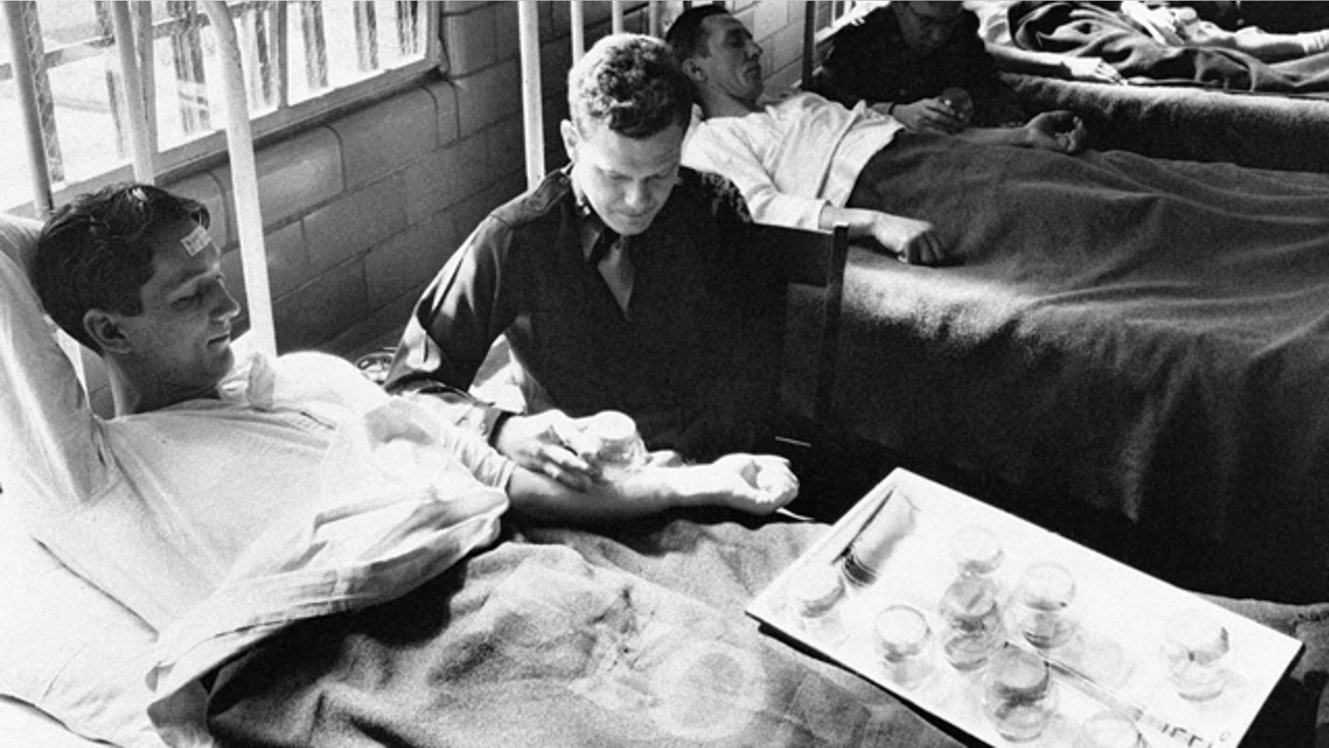 In this June 25, 1945 picture, army doctors expose patients to malaria-carrying mosquitoes in the malaria ward at Stateville Penitentiary in Crest Hill, Ill.