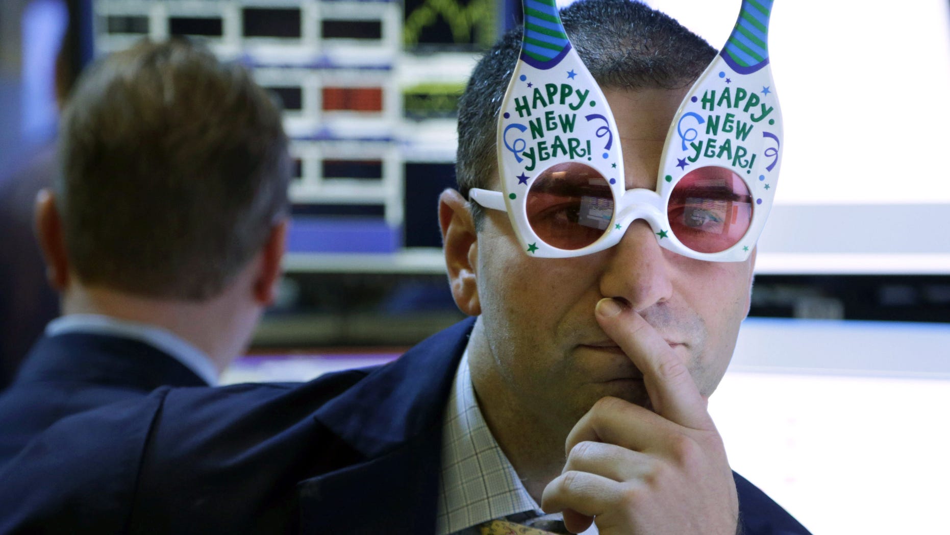FILE - In this Monday, Dec. 31, 2012, file photo, a trader wearing "Happy New Year" glasses works on the floor at the New York Stock Exchange in New York. According to an Associated Press-GfK poll released Monday, Dec. 16, 2013, Americans dont expect another gangbuster year for the stock market. Of the people polled, 40 percent think the market will stabilize at current levels by the end of 2014, with 39 percent predicting that it will drop, but not crash. Only 14 percent believe the market will rise and 5 percent think that the market will crash (AP Photo/Seth Wenig, File)
