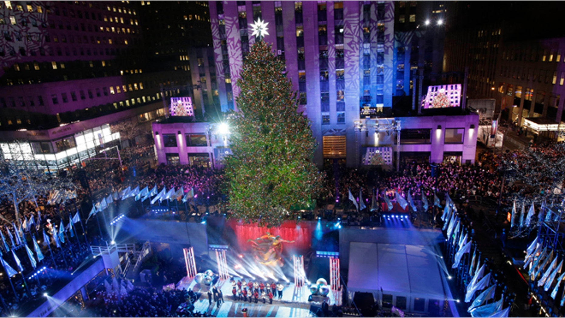 The Rockefeller Center Christmas tree is lit during a ceremony, Wednesday, Dec. 4, 2013, in New York.