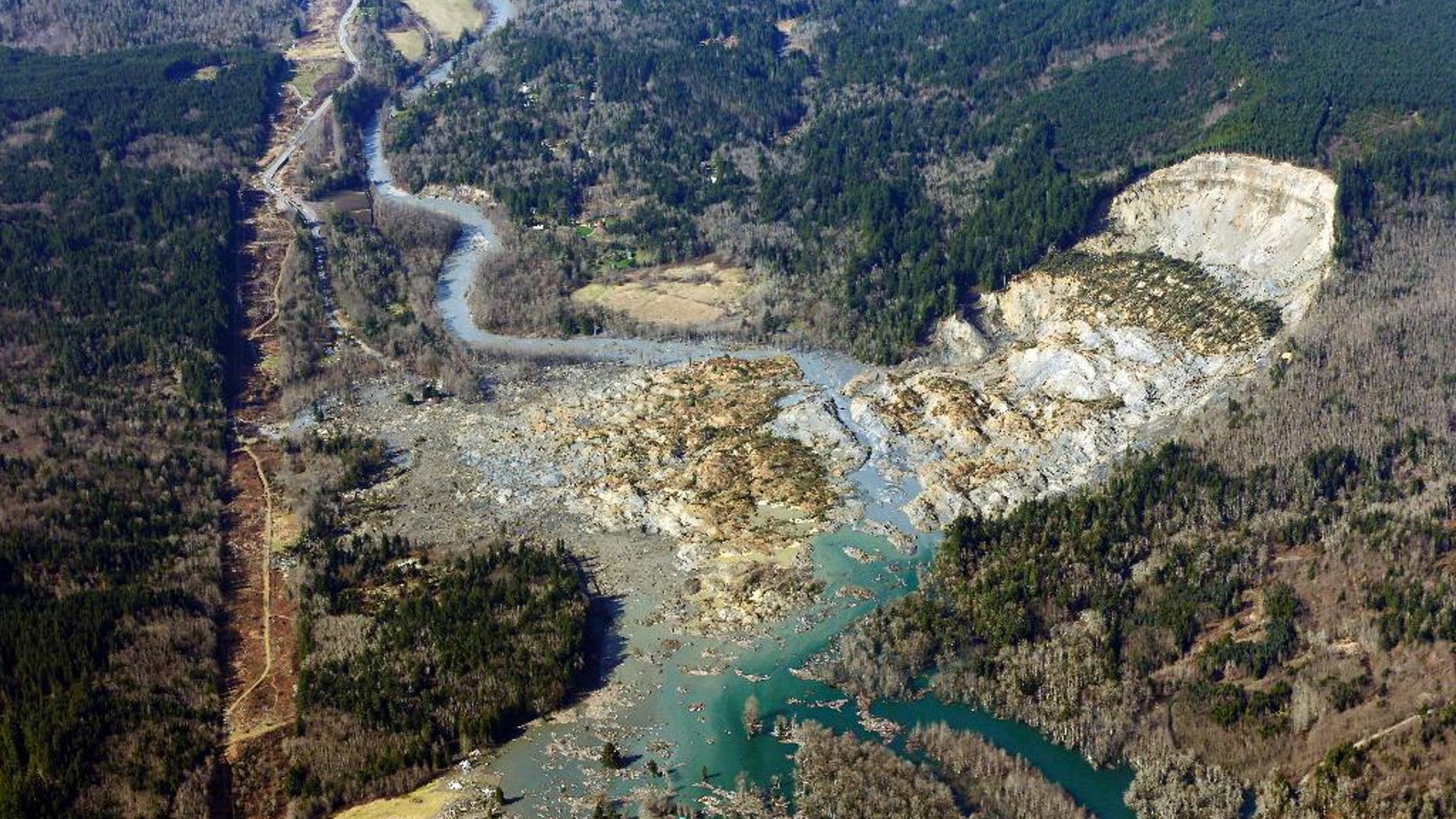 AP10ThingsToSee - This aerial photo taken Monday, March 24, 2014 shows the massive mudslide that killed at least eight people Saturday and left dozens missing, near Arlington, Wash. (AP Photo/Ted S. Warren, File)