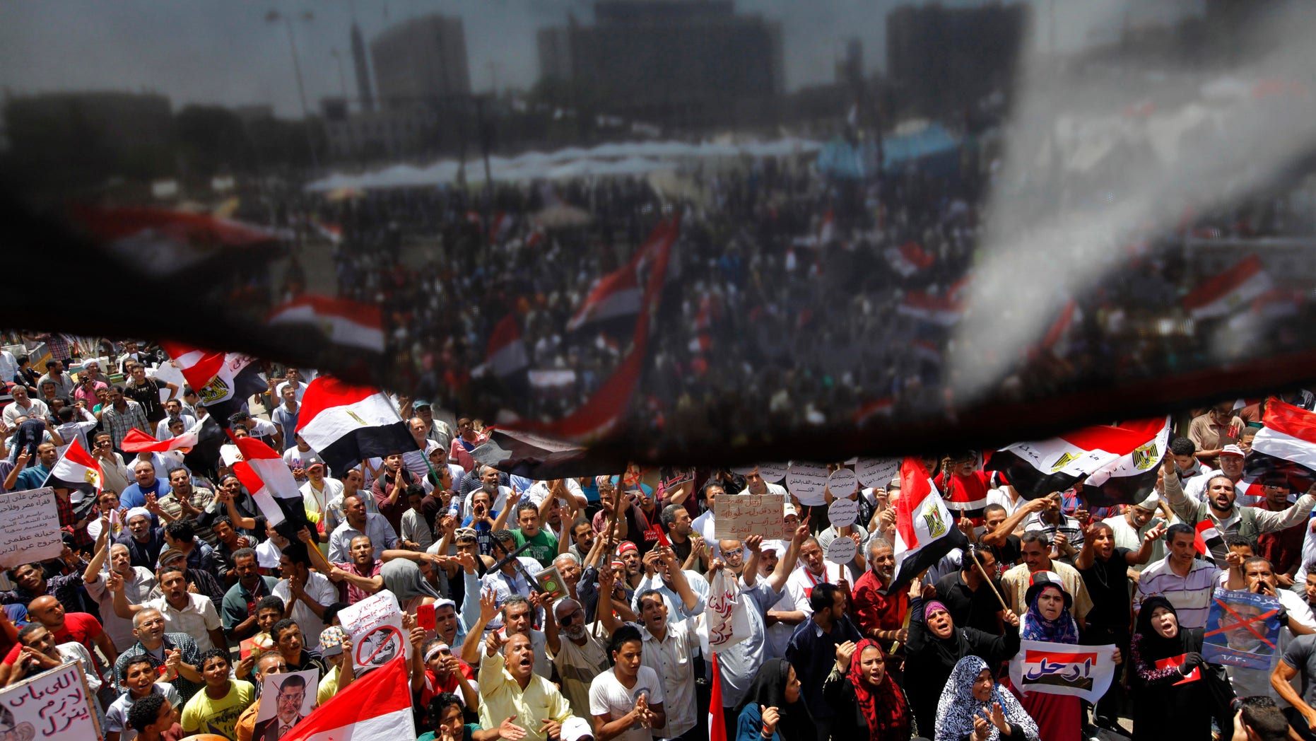 Opponents of Egypt's Islamist President Mohammed Morsi wave national flags as they demonstrate in Tahrir Square in Cairo, Egypt, Friday, June 28, 2013. (AP Photo/Amr Nabil)