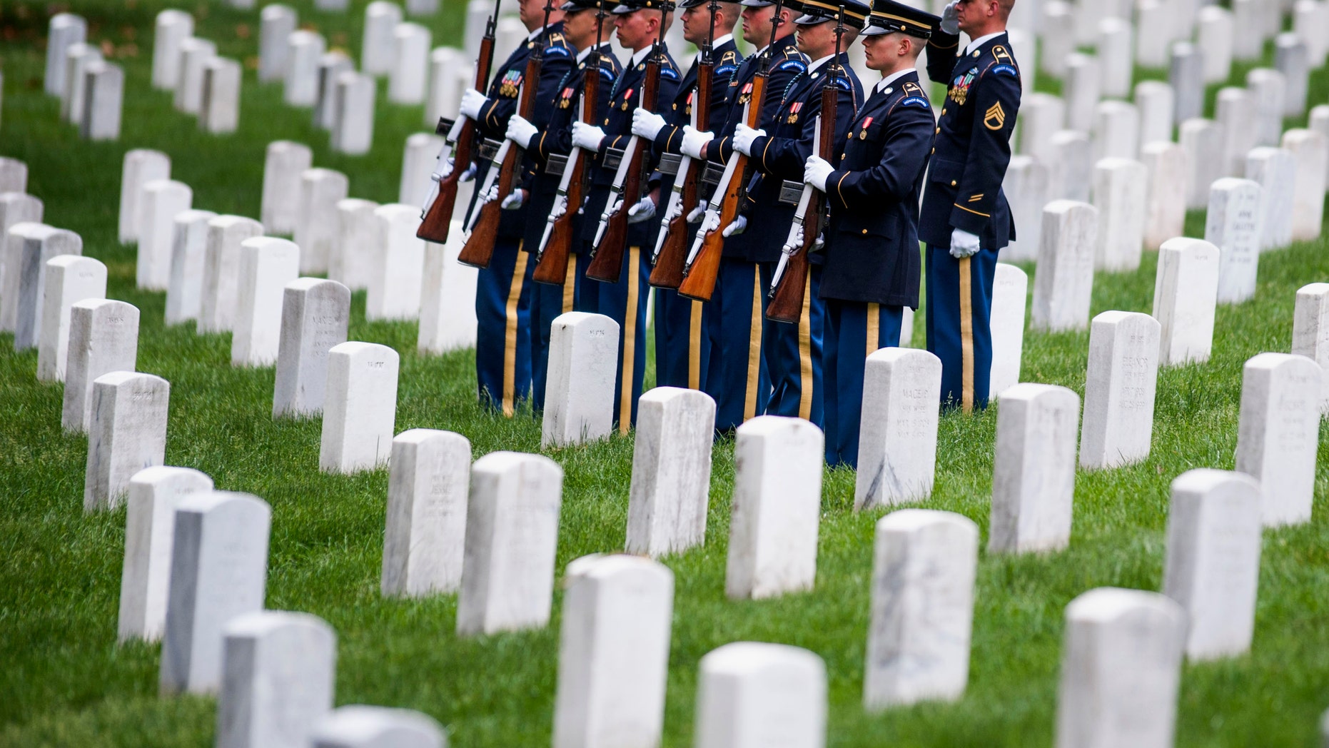 In this May 29, 2014 file photo, a firing party stands at attention during burial services at Arlington National Cemetery in Arlington, Va.