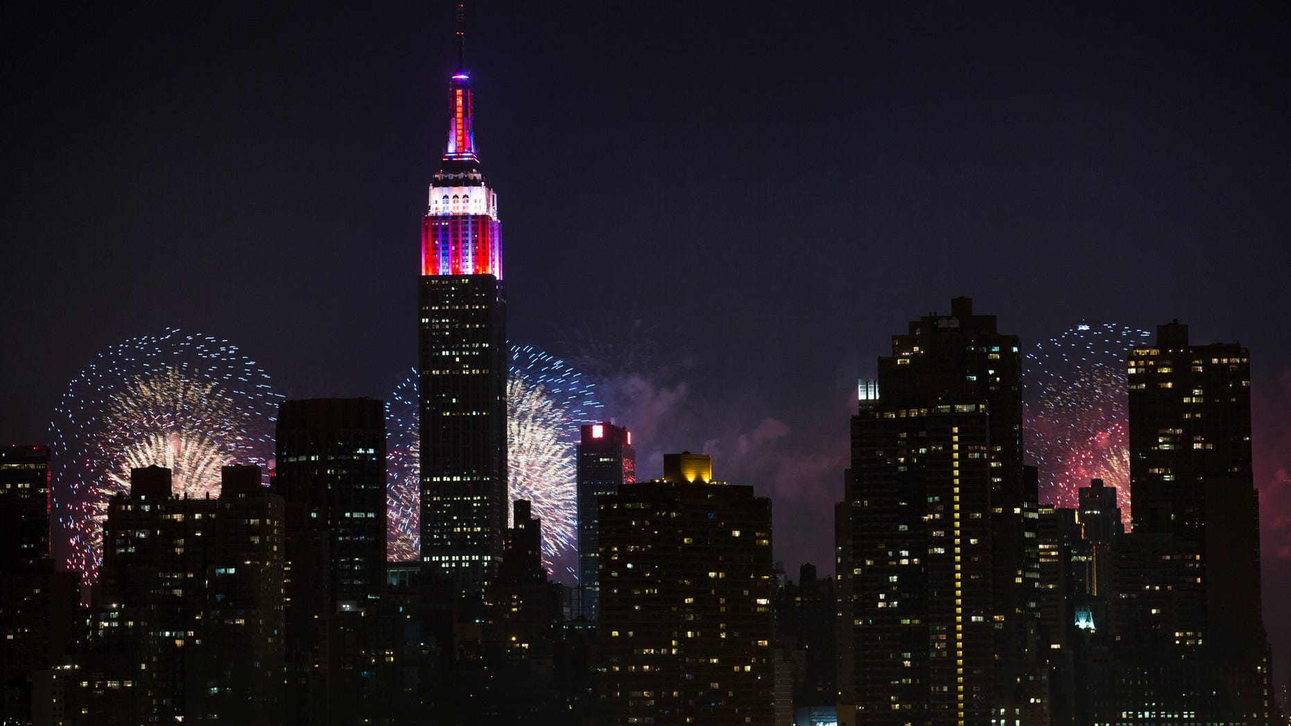 Fireworks light up the Empire State Building along the Manhattan skyline during Macy's 37th Annual Fourth of July fireworks show, Thursday, July 4, 2013, in New York. (AP Photo/John Minchillo)