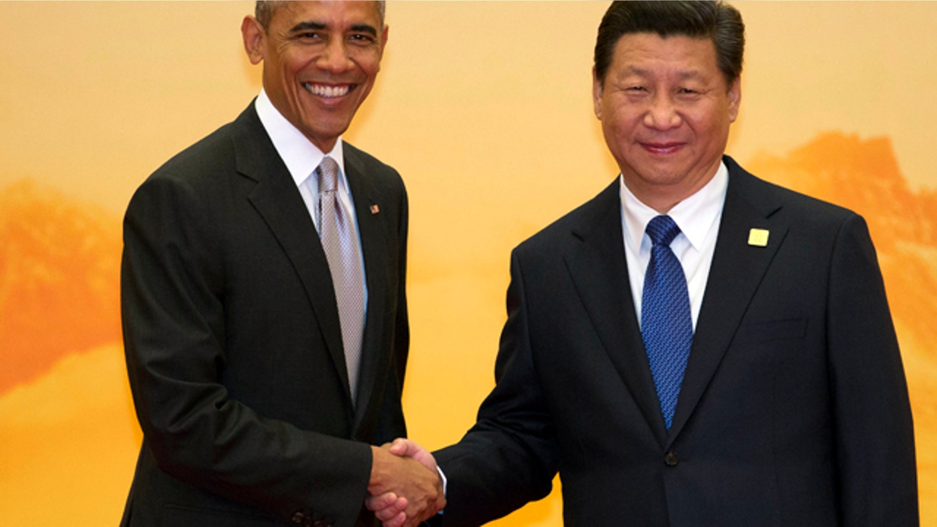 November 11, 2014: U.S. President Barack Obama, left, shakes hands with Chinese President Xi Jinping during a welcome ceremony for the Asia-Pacific Economic Cooperation (APEC) summit at the International Convention Center in Yanqi Lake, Beijing. (AP Photo/Ng Han Guan)