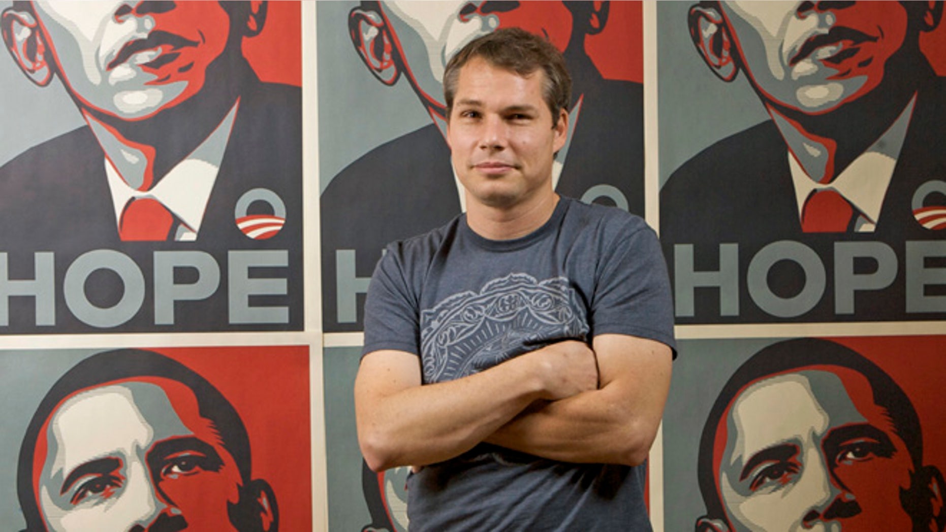 Jan. 12, 2009: In this file photo, Los Angeles street artist Shepard Fairey poses in front of the Barack Obama Hope artwork he designed in the Echo Park area of Los Angeles.