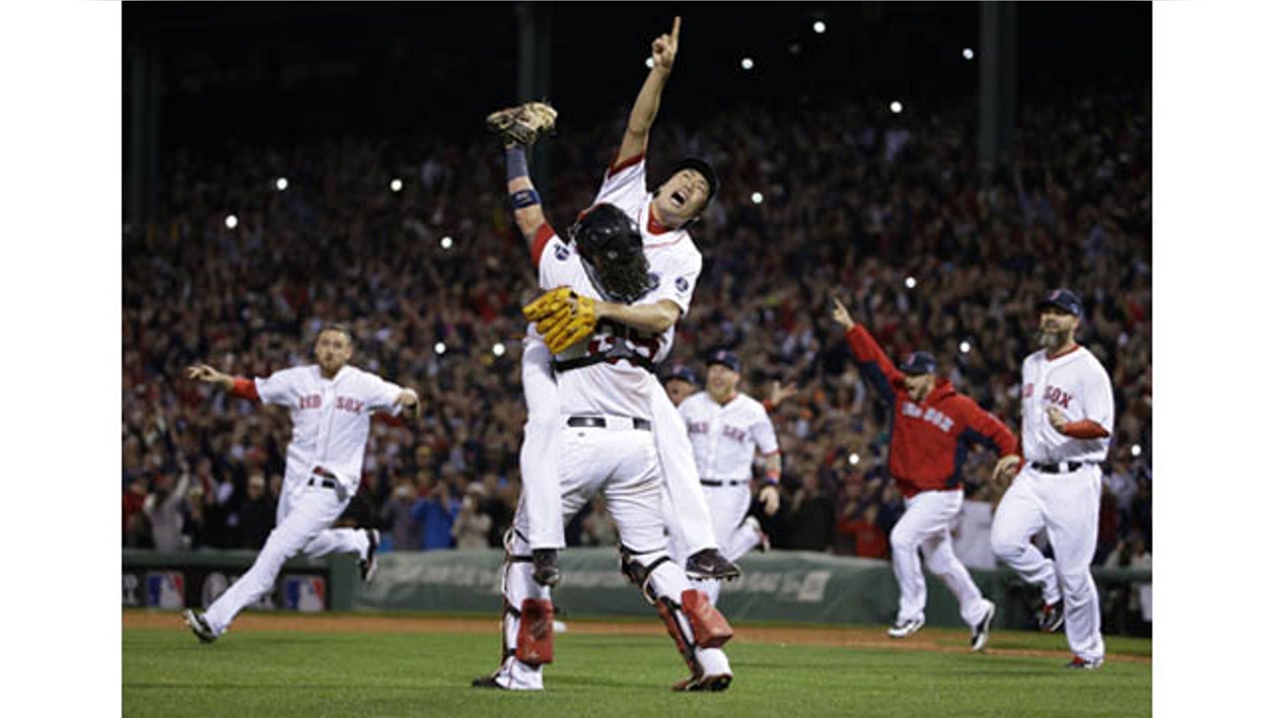 October 19, 2013: Boston Red Sox relief pitcher Koji Uehara, rear, and catcher Jarrod Saltalamacchia celebrate the Red Sox 5-2 win over the Detroit Tigers in Game 6 of the American League baseball championship series on Saturday, Oct. 19, 2013, in Boston. (AP Photo)