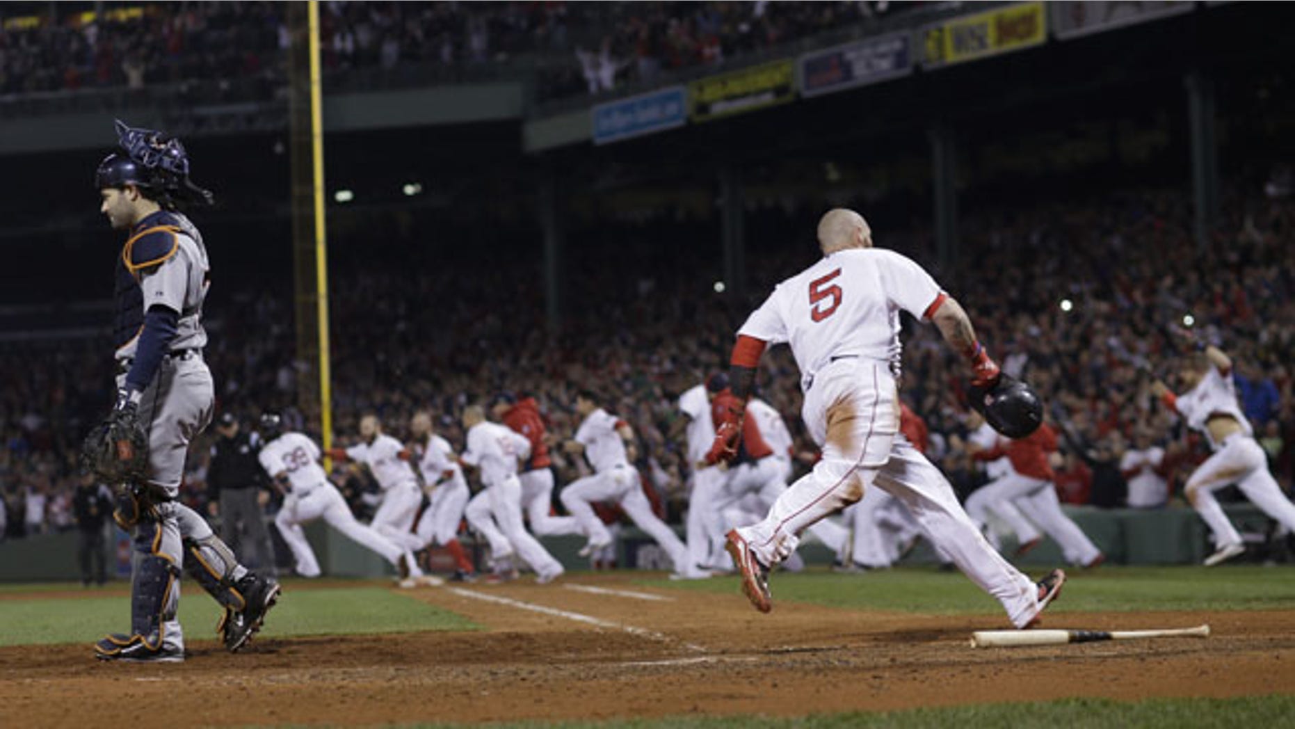 October 13, 2013: Boston Red Sox's Jonny Gomes scores the winning run on a hit by Jarrod Saltalamacchia during Game 2 of the American League baseball championship series against the Detroit Tigers Sunday in Boston. (AP Photo)