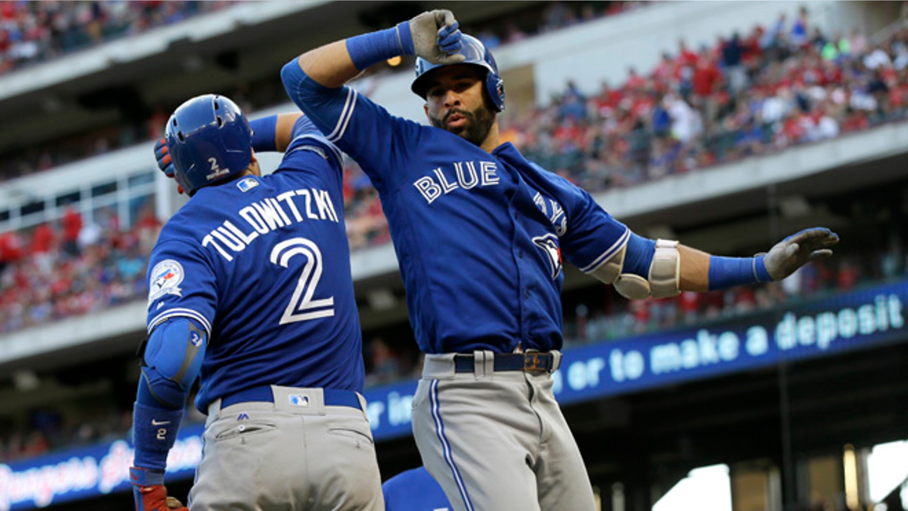 Toronto Blue Jays' Troy Tulowitzki and Jose Bautista celebrate on Oct. 6, 2016.