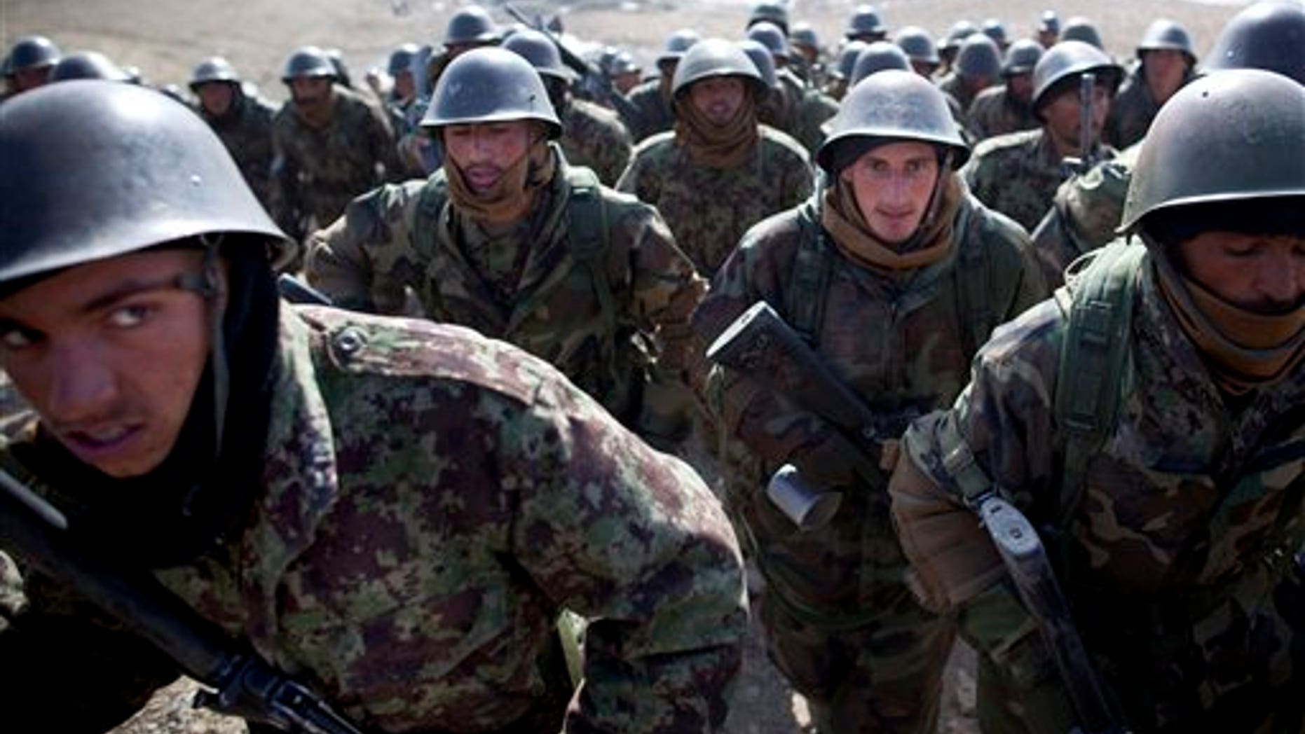 March 8: Afghan National Army soldiers walk up a hill as they arrive for a training session at the Kabul Military Training Center, KMTC, on the outskirts of Kabul, Afghanistan. The Afghan National Army will be tasked with providing security throughout Afghanistan after the last international troops pull out in 2014.