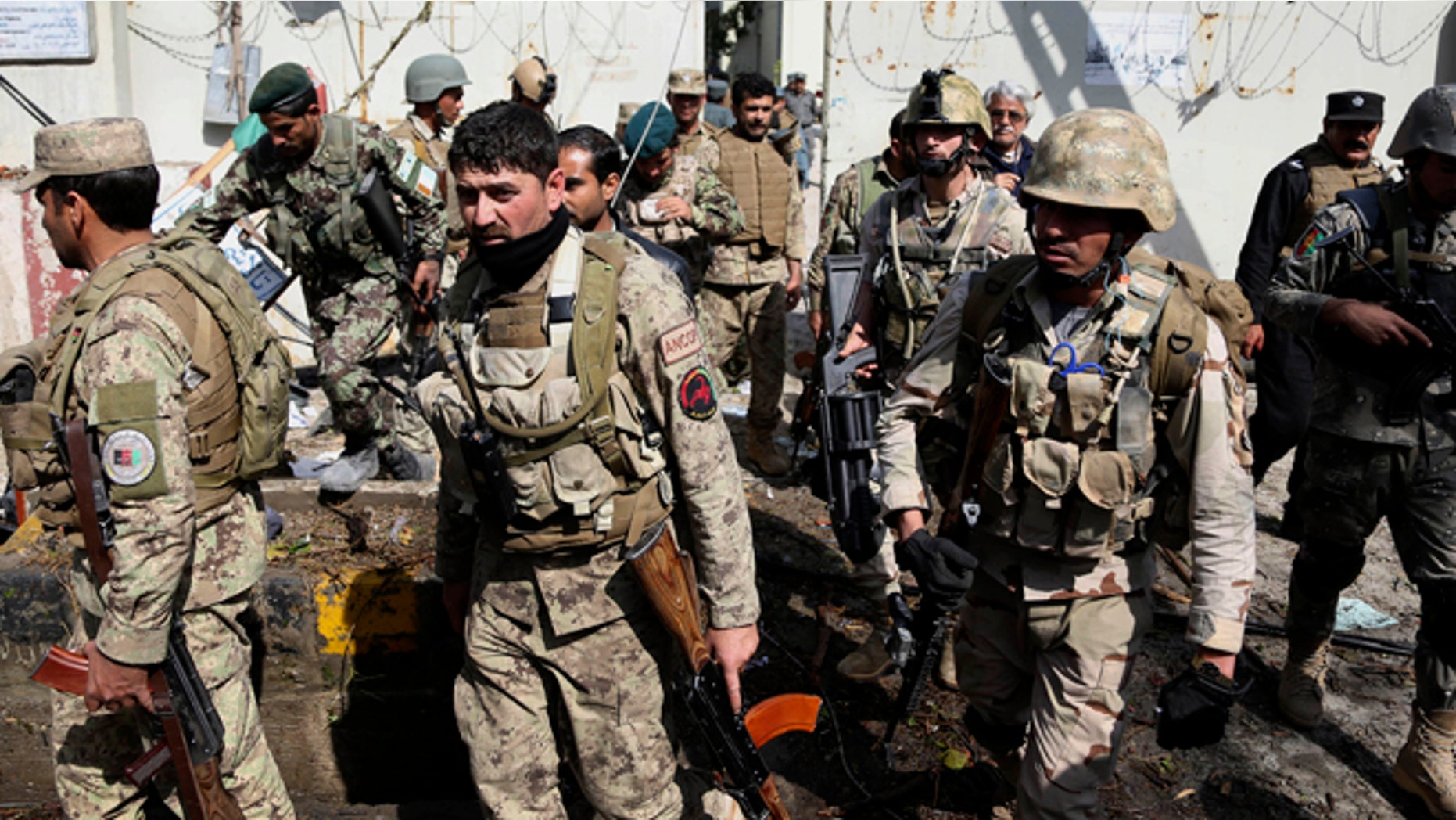 March 20, 2014: Afghan Army and police search through a police station after the Taliban staged a multi-pronged attack on a police station in Jalalabad, eastern Afghanistan.