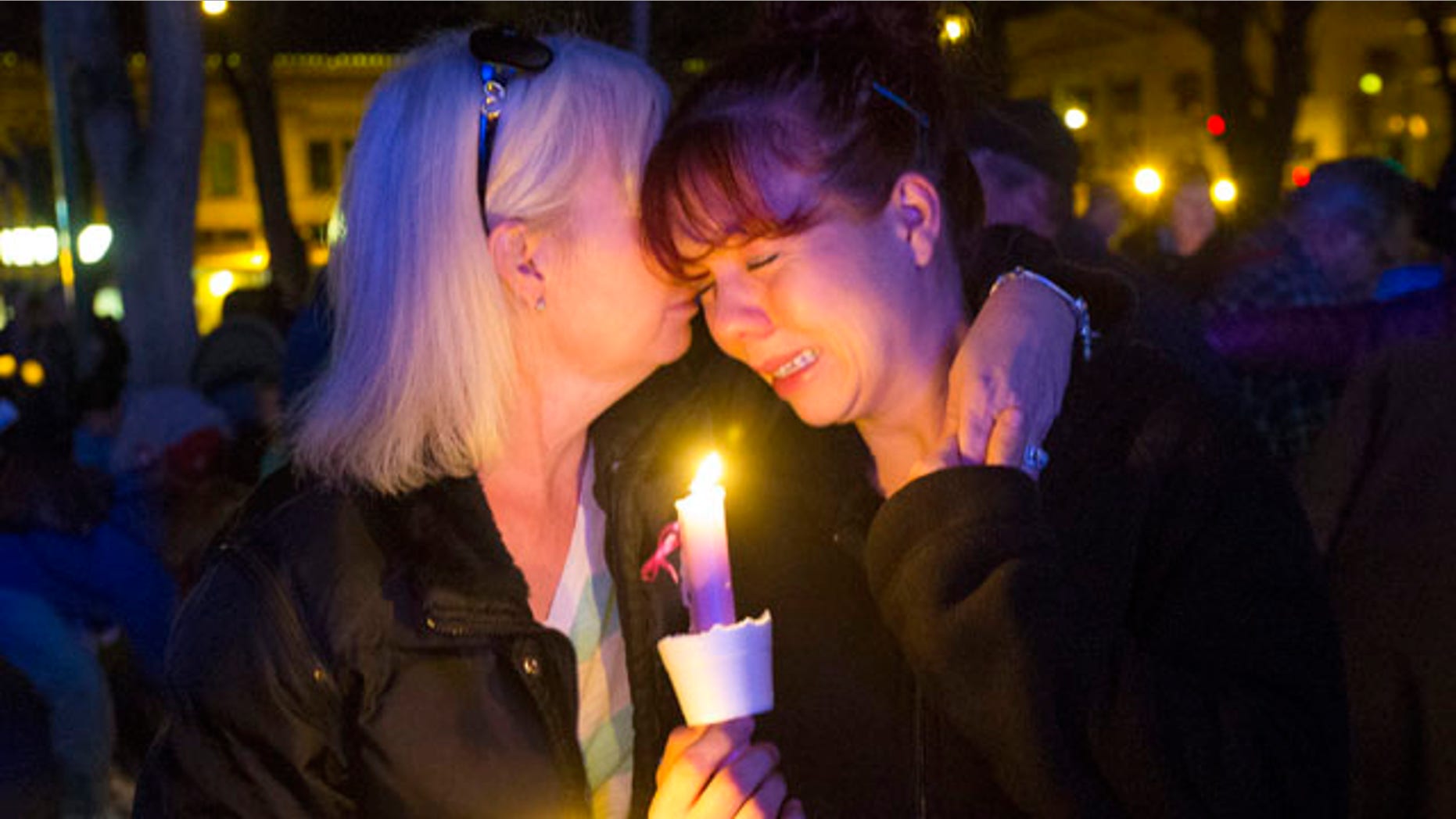 Feb. 18, 2015: Tonya Castillo, left, comforts her daughter Tiffany Reid during a candlelight memorial for Kayla Mueller in Prescott, Ariz. (AP Photo/The Arizona Republic, Michael Chow)