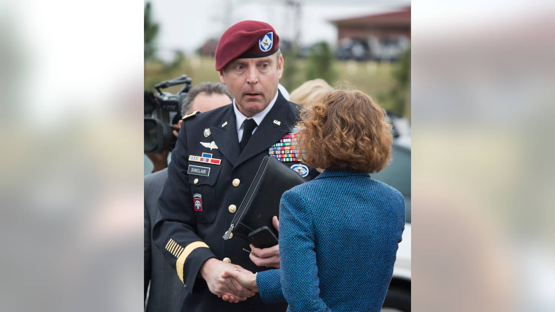 Brig. Gen. Jeffrey Sinclair shakes hands with his defense attorney Ellen C. Brotman outside the Fort Bragg, N.C., courthouse, Monday, March 17, 2014. Sinclair, who admitted to improper relationships with three subordinates, appeared to choke up as he told a judge that he'd failed the female captain who had leveled the most serious accusations against him. (AP Photo/The Fayetteville Observer, Johnny Horne)