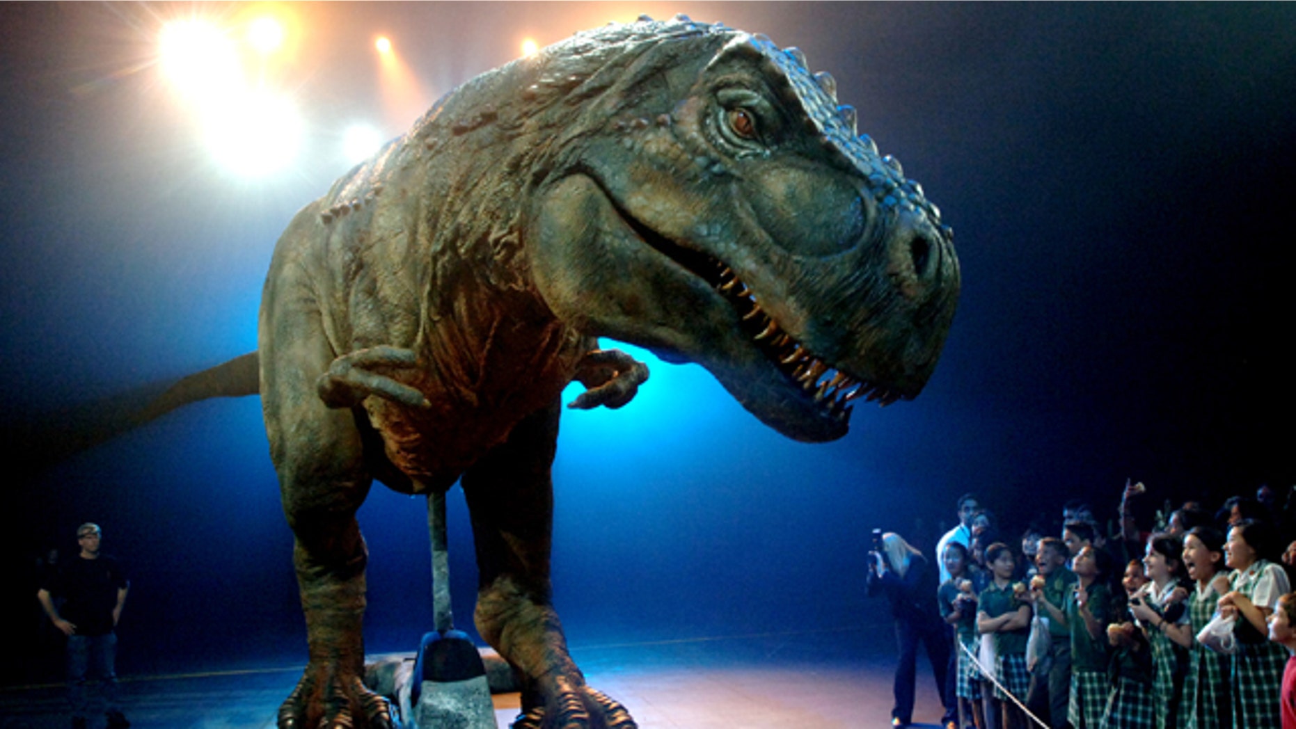 School children react as they stare at an animatronic dinosaur during a media call for the Walking with Dinosaurs arena spectacular in Sydney, Monday, Oct. 18, 2010. Australia's most successful entertainment export, the life-sized dinosaurs have played to six and half million people worldwide and generated more than $344 million U.S. in ticket sales.