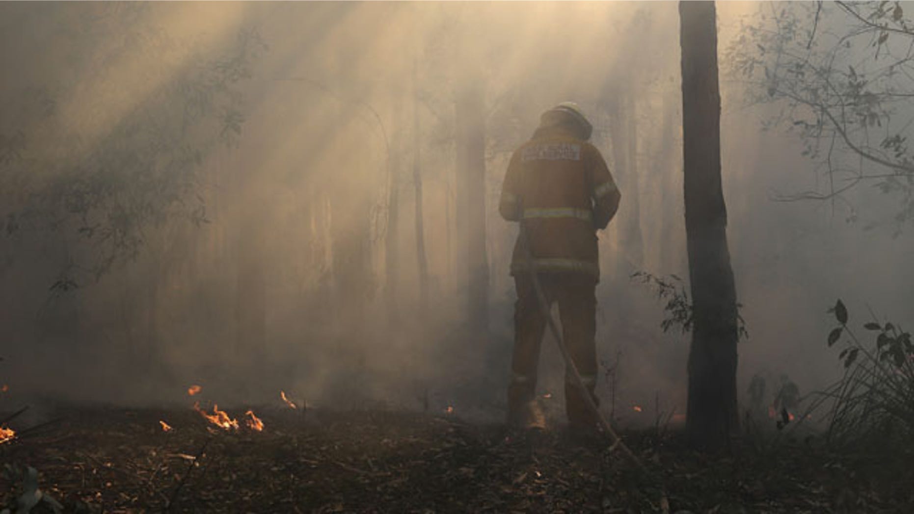 October 23, 2013: A firefighter mops up after a firestorm swept through a property in Bilpin, 47 miles from Sydney, Australia (AP Photo)