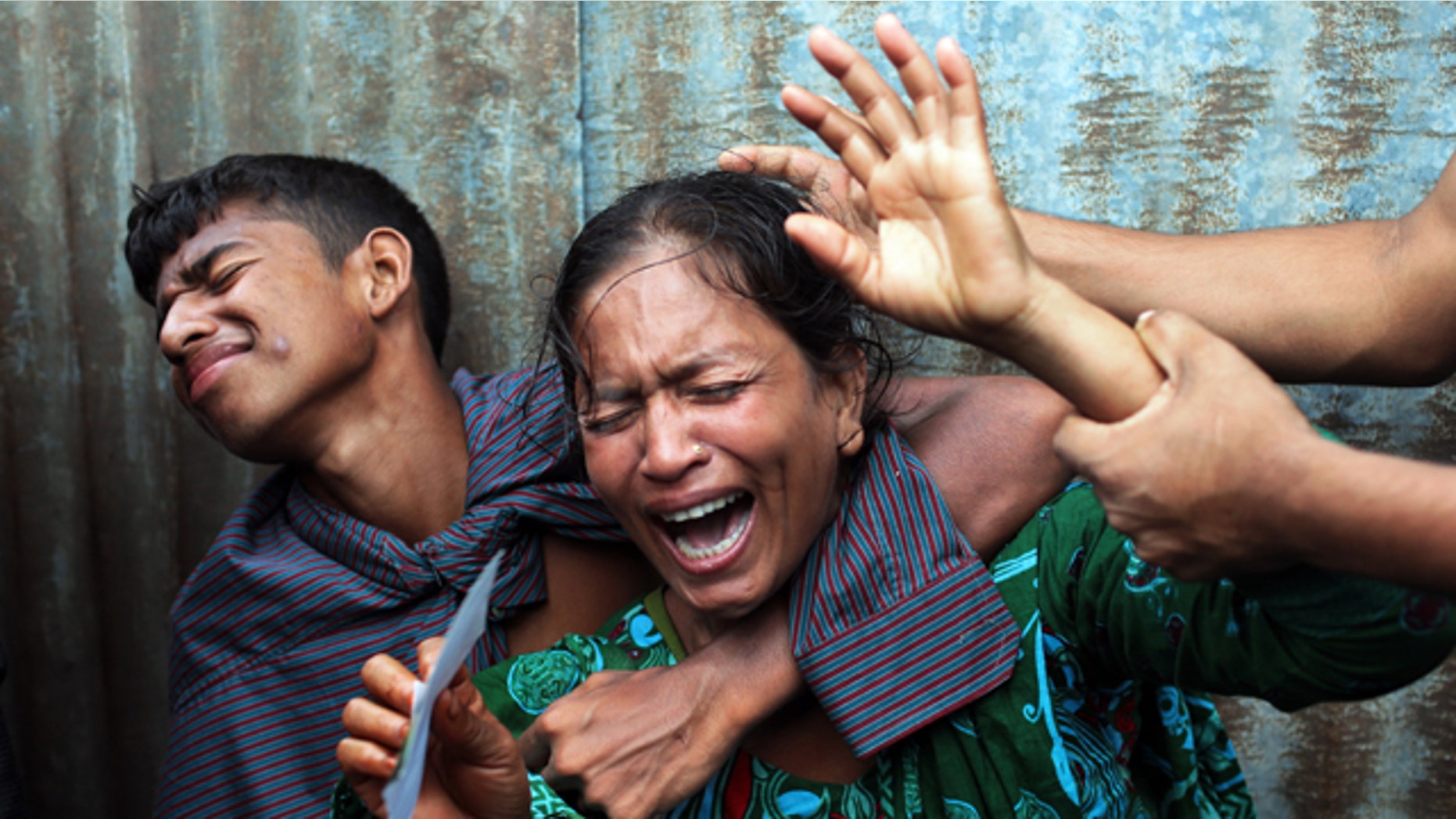 August 4, 2014: Bangladeshi woman Munni, whose daughters are missing, cries as rescuers search the River Padma after a passenger ferry capsized in Munshiganj district. (AP Photo/ A.M. Ahad)