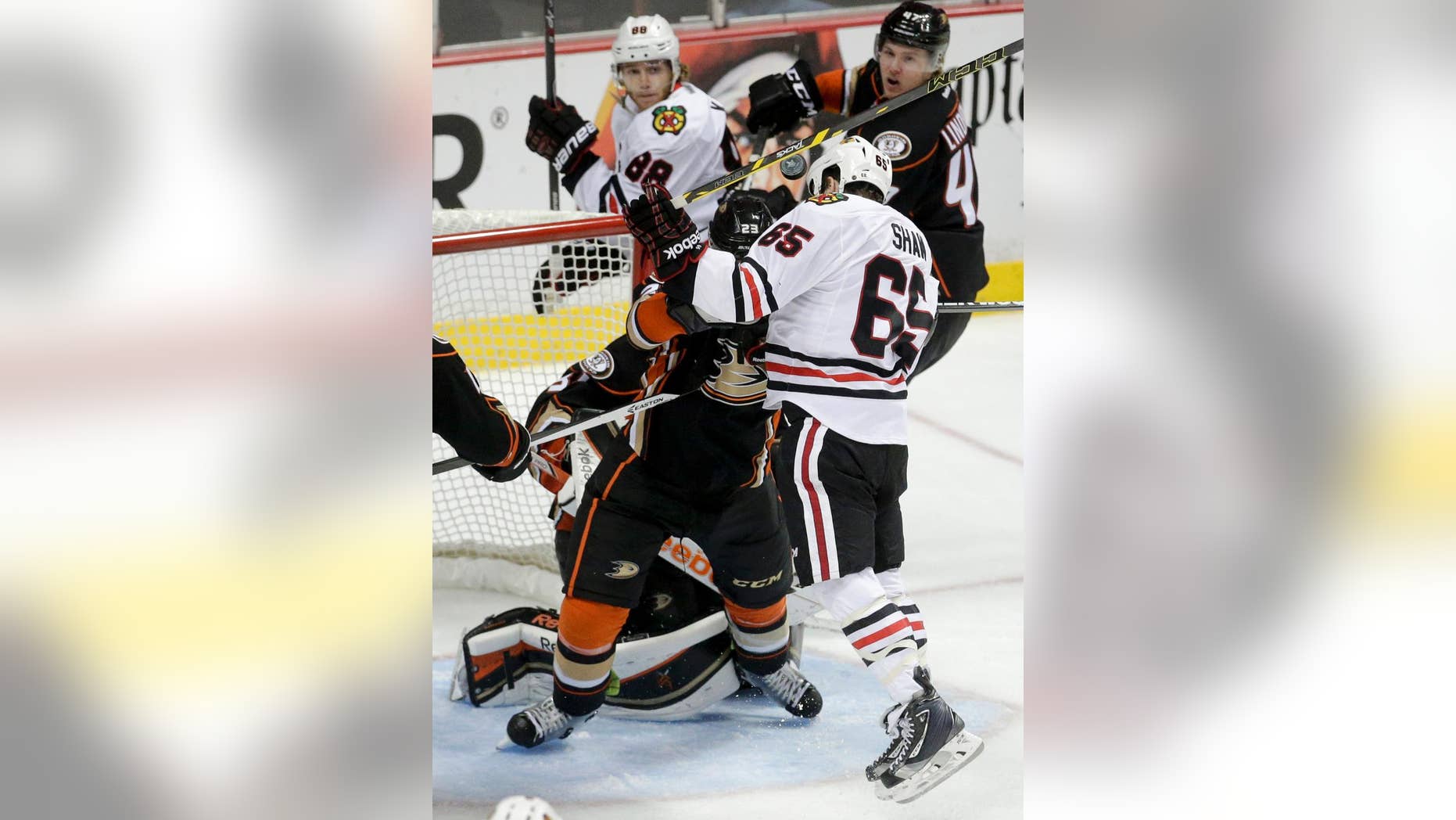 Chicago Blackhawks center Andrew Shaw head-butts the puck into the goal during overtime in Game 2 of the Western Conference final during the NHL hockey Stanley Cup playoffs against the Anaheim Ducks in Anaheim, Calif., on Tuesday, May 19, 2015. The apparent goal was disallowed. (AP Photo/Jae C. Hong)