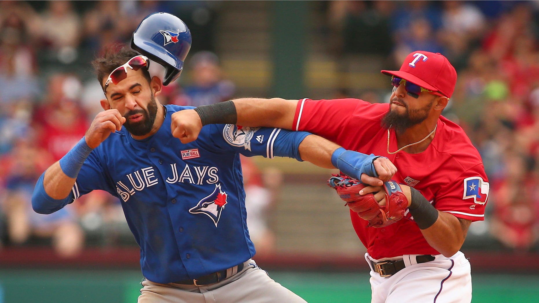 Toronto Blue Jays Jose Bautista (19) gets hit by Texas Rangers second baseman Rougned Odor (12) after Bautista slid into second in the eighth inning of a baseball game at Globe Life Park in Arlington, Texas, Sunday May 15, 2016. (Richard W. Rodriguez/Star-Telegram via AP)