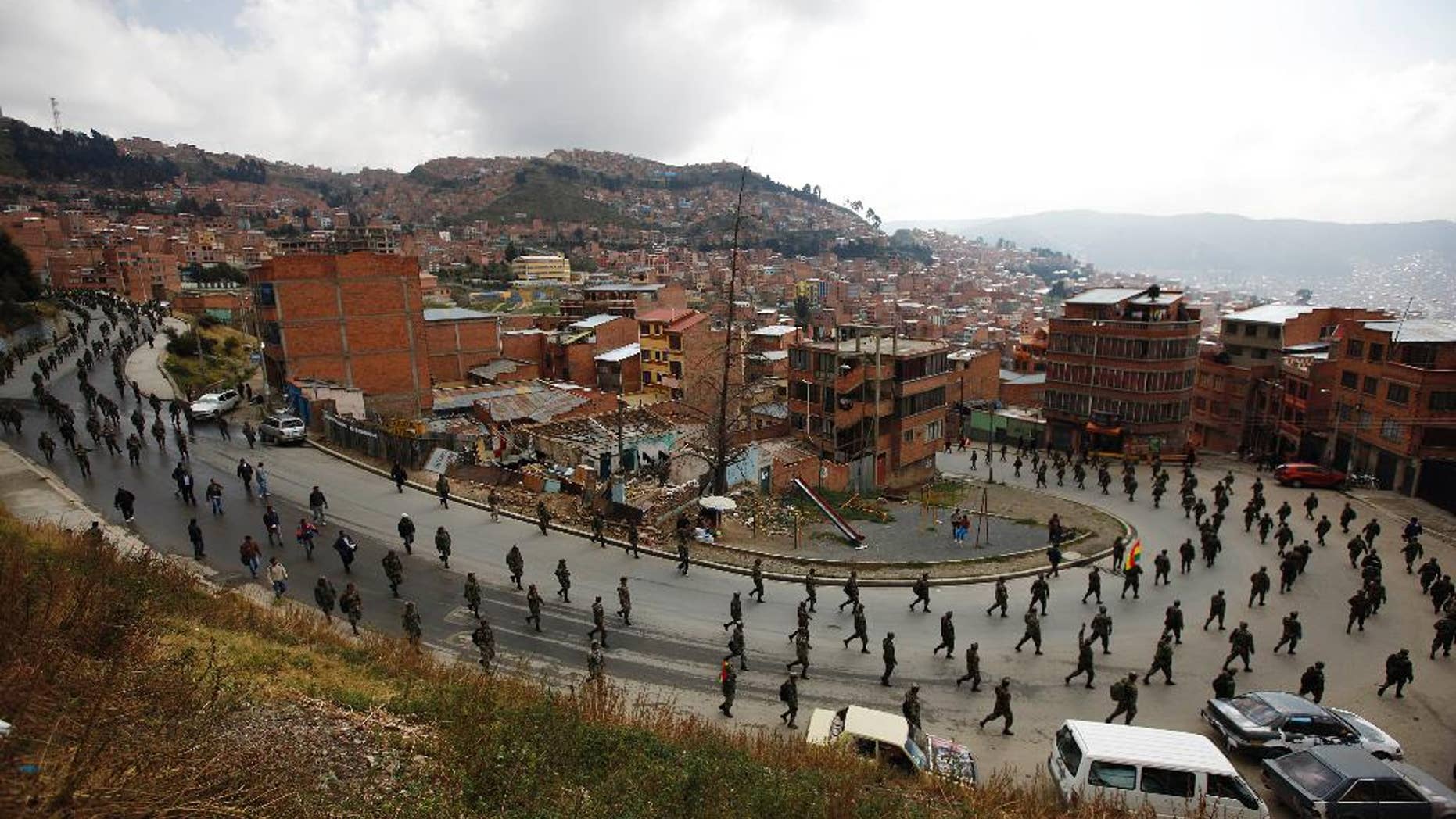 Low ranking soldiers march on the third day of protests in La Paz, Bolivia, Thursday, April 24, 2014. Enlisted soldiers are protesting the military high command's dismissal of four of its leaders who defended their call for changes so that non-commissioned officers may study to become career officers. (AP Photo/Juan Karita)
