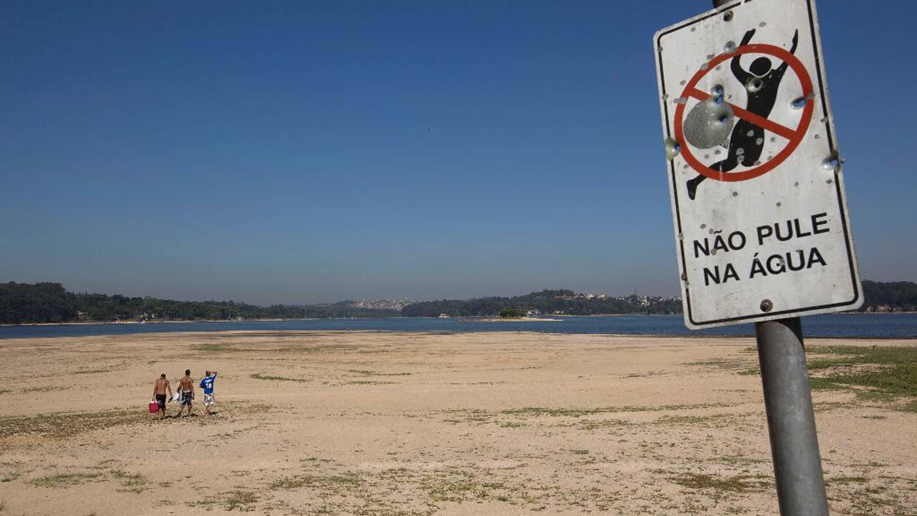 Oct. 29, 2014: Men walk on the receding banks of the Guarapiranga dam which is responsible for providing water to the Sao Paulo metropolitan area in Brazil