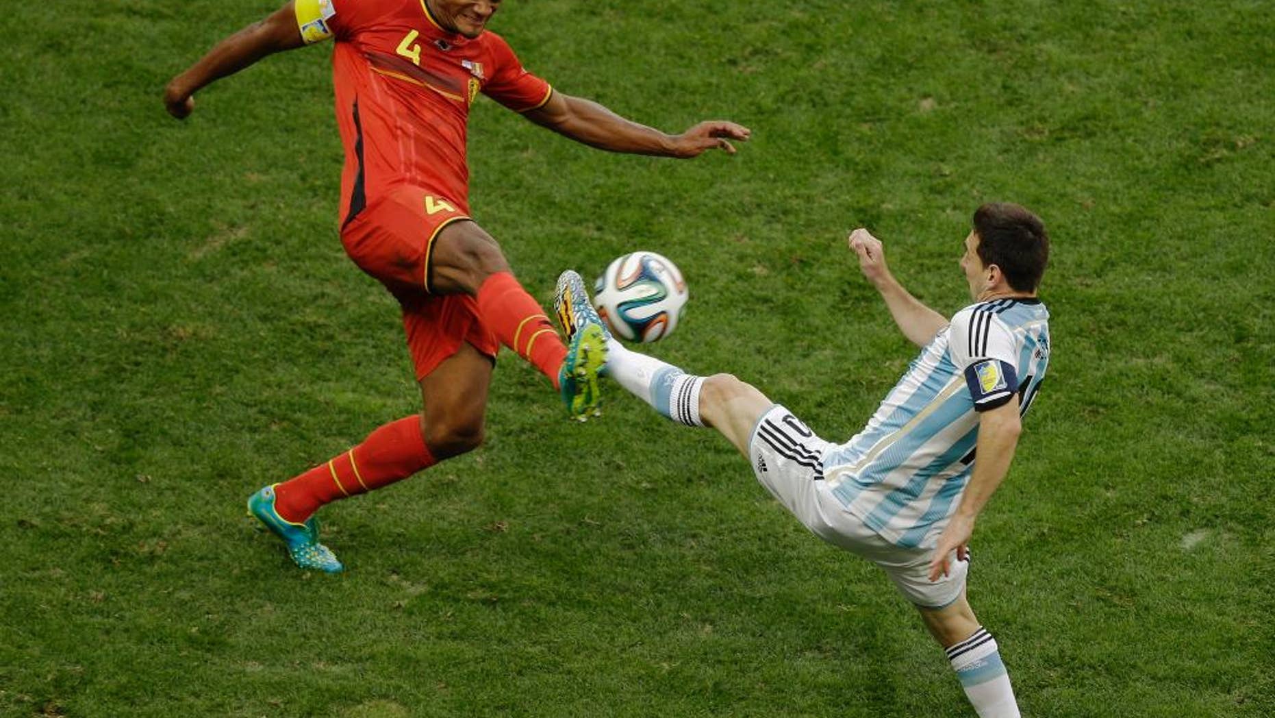 Belgium's Vincent Kompany, left, and Argentina's Lionel Messi fight for the ball during the World Cup quarterfinal soccer match between Argentina and Belgium at the Estadio Nacional in Brasilia, Brazil, Saturday, July 5, 2014. (AP Photo/Thanassis Stavrakis)